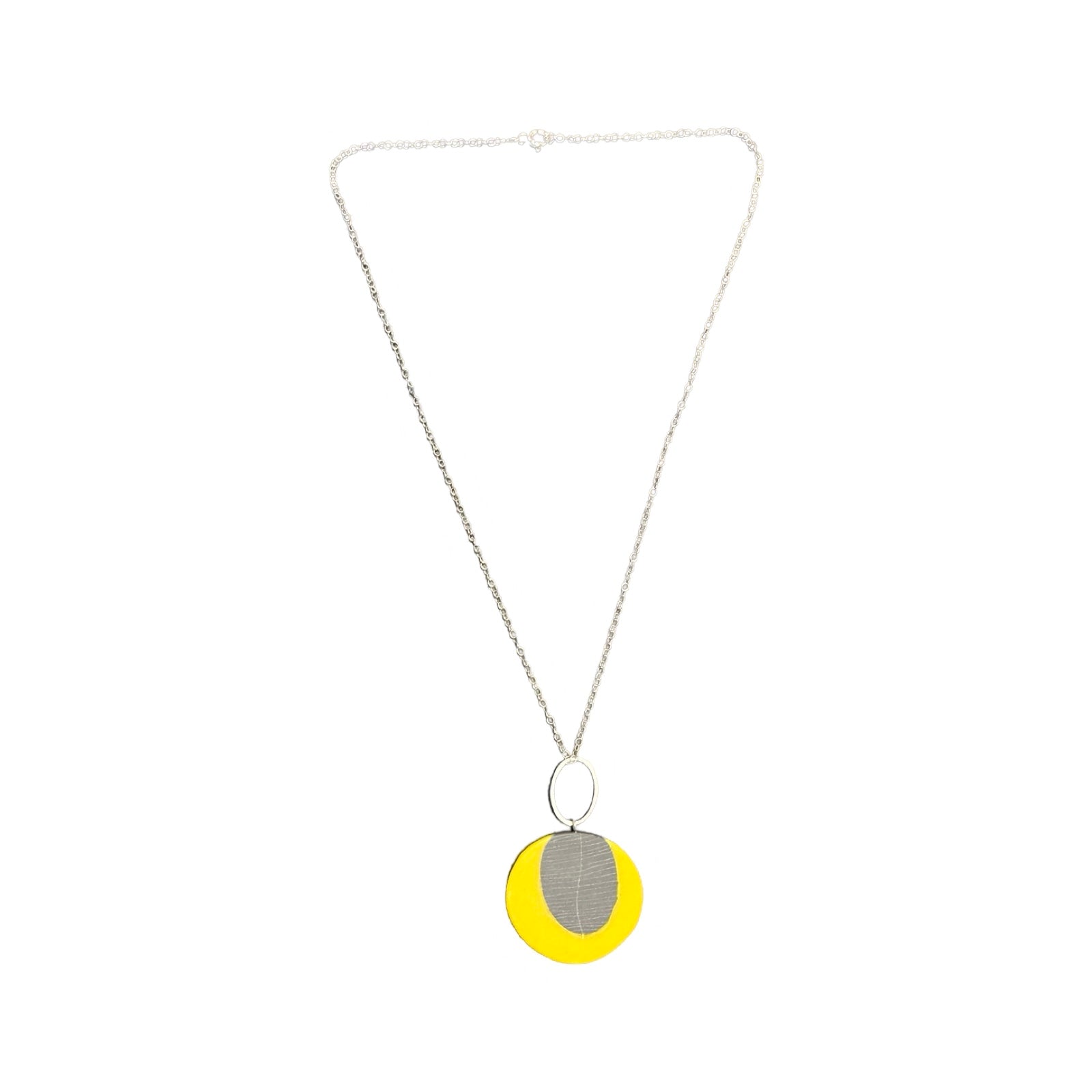 Yellow circular pendant necklace made from resin with a grey leaf in the centre on a silver chain.