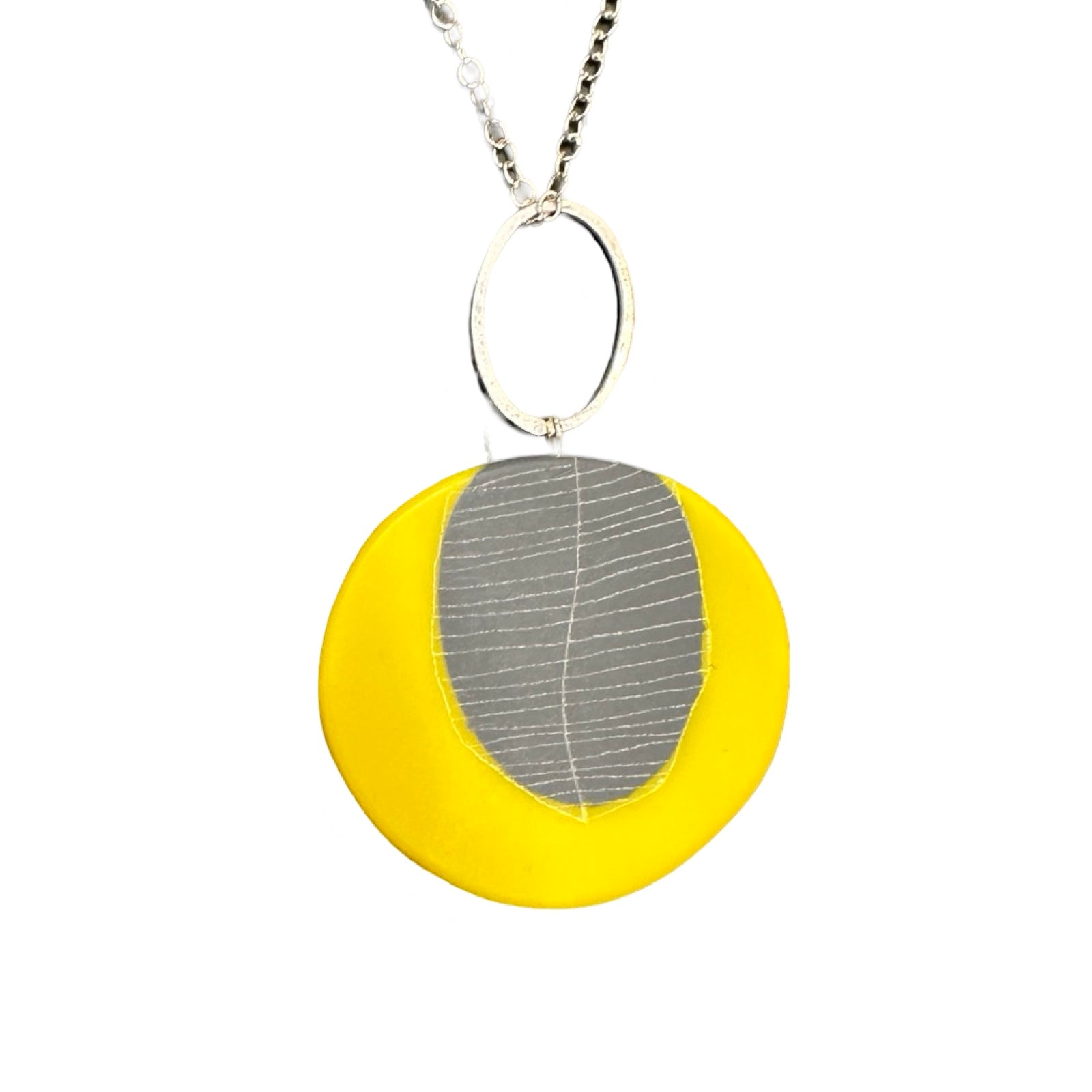 Yellow circular pendant necklace made from resin with a grey leaf in the centre on a silver chain.