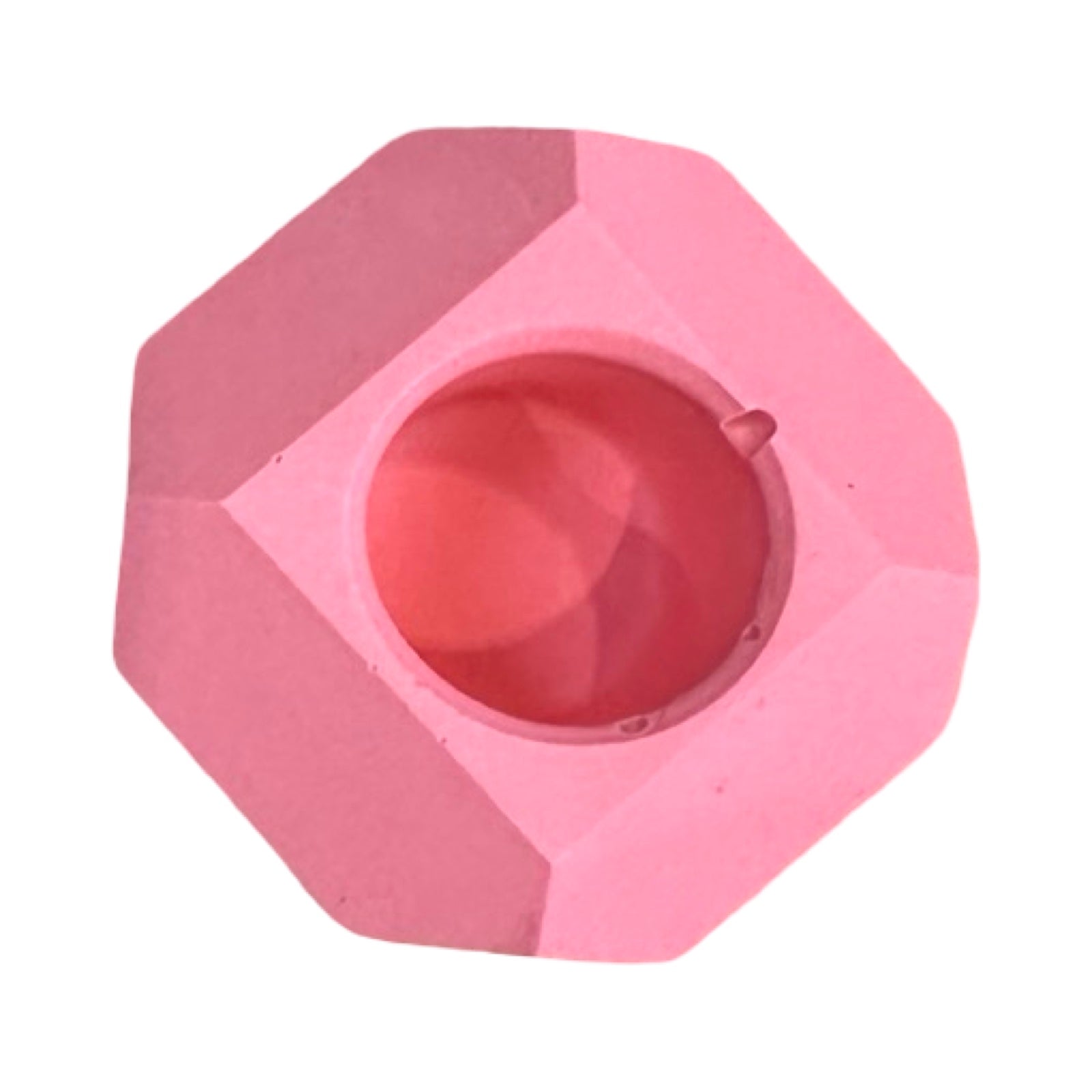 The top of a small geometric shaped dinner candle holder in pink.