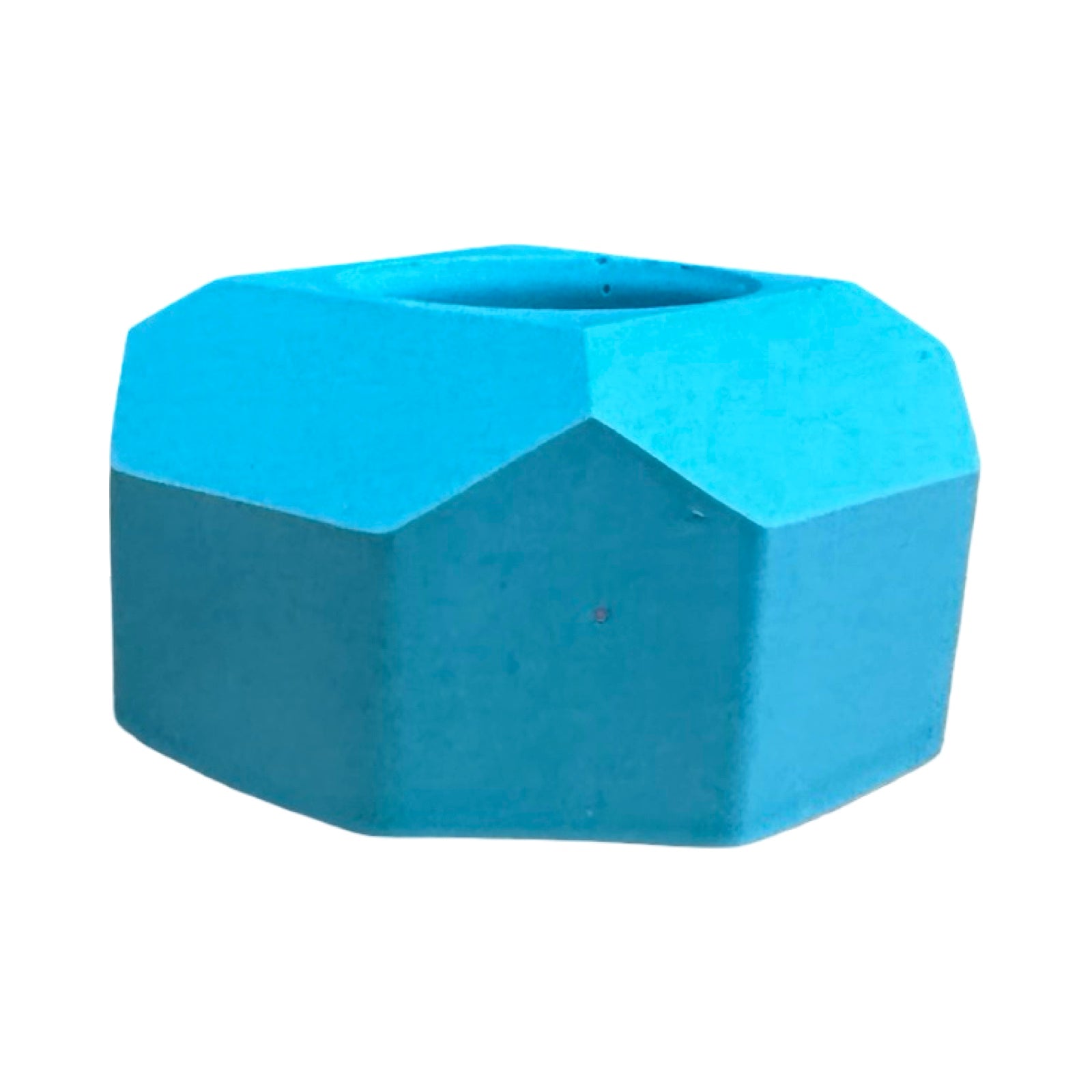 The side of a small geometric shaped dinner candle holder in turquoise.