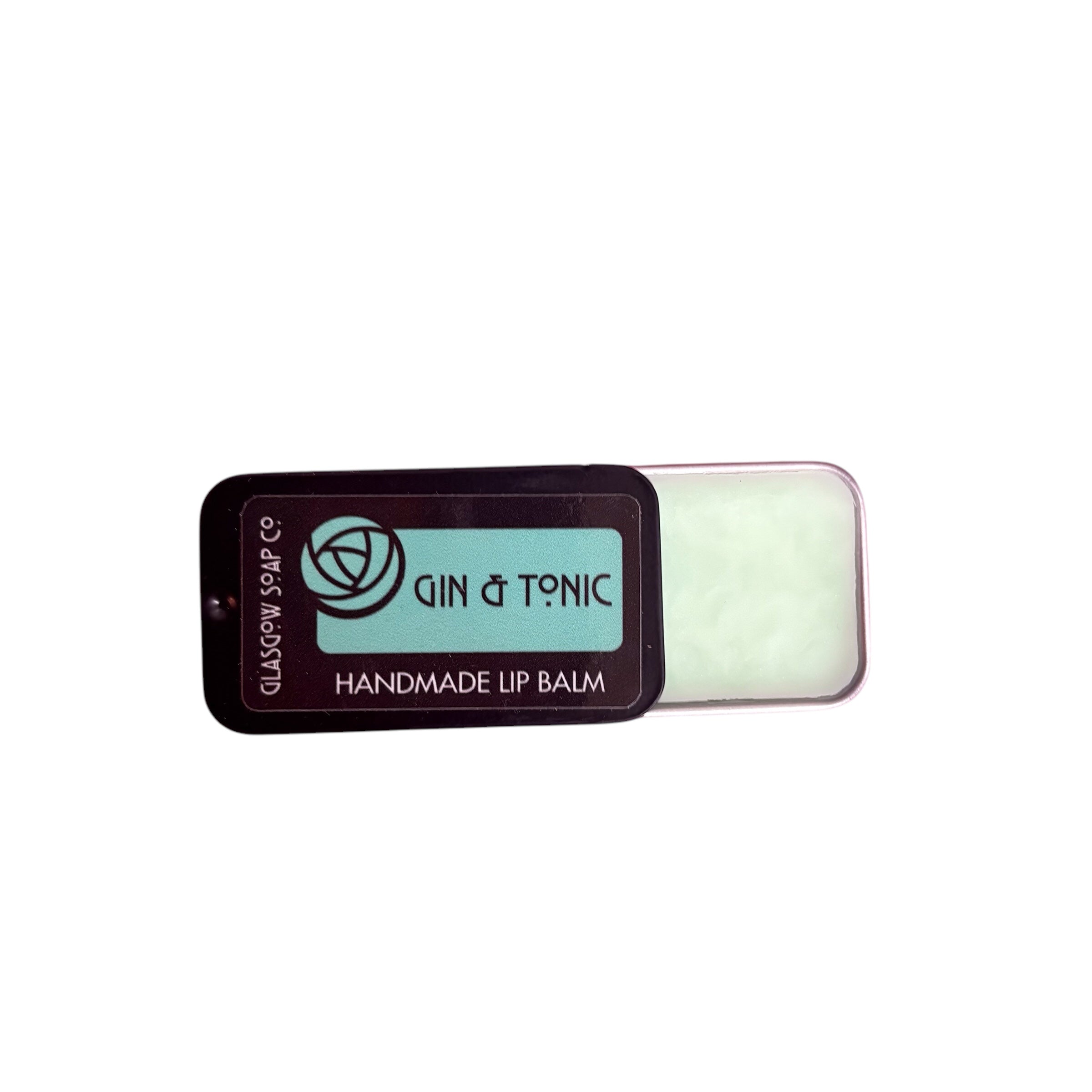 A small black tin of gin and tonic lip balm, half open.
