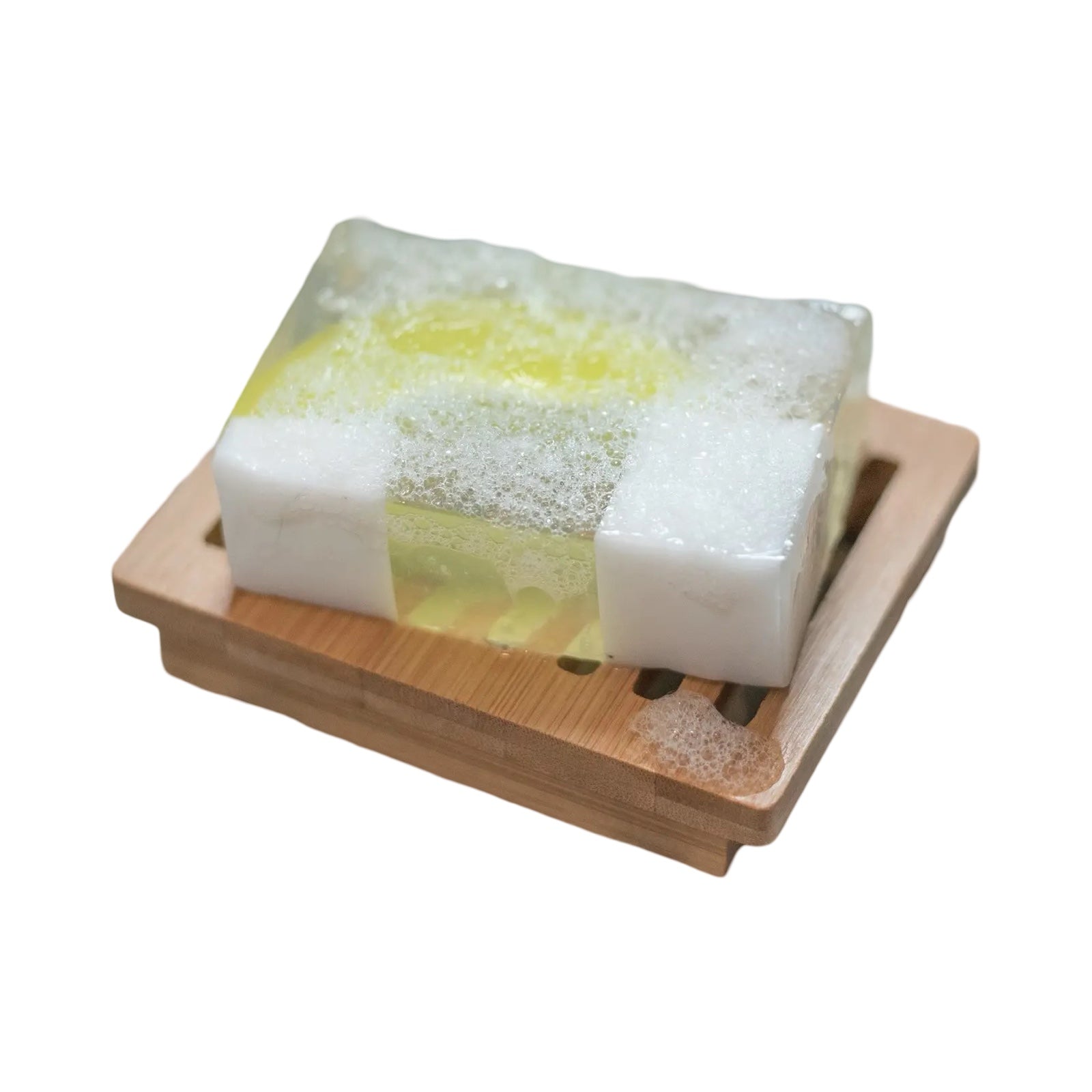 A bar of green and white gin and tonic soap sitting on a wooden soap dish.