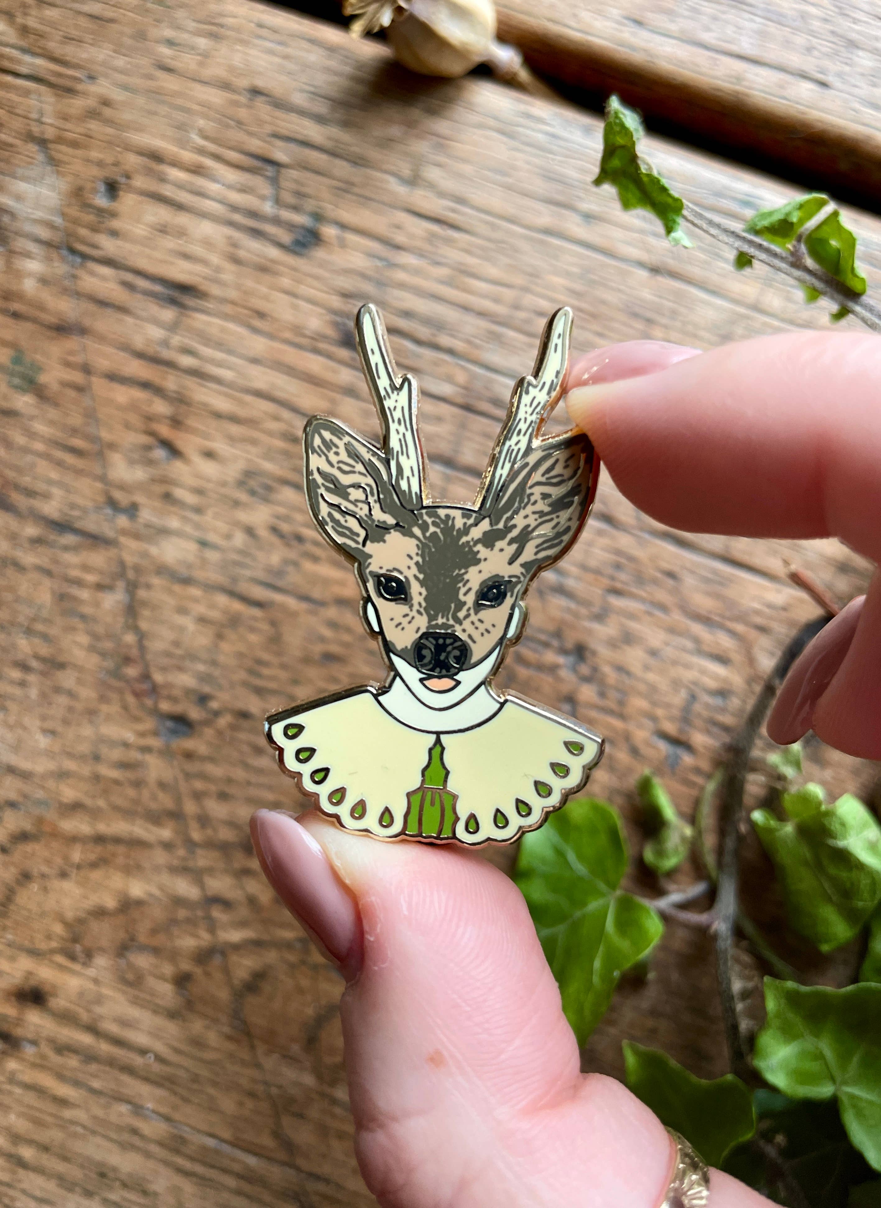 This enamel pin badge features a girl's head wearing a deer mask.