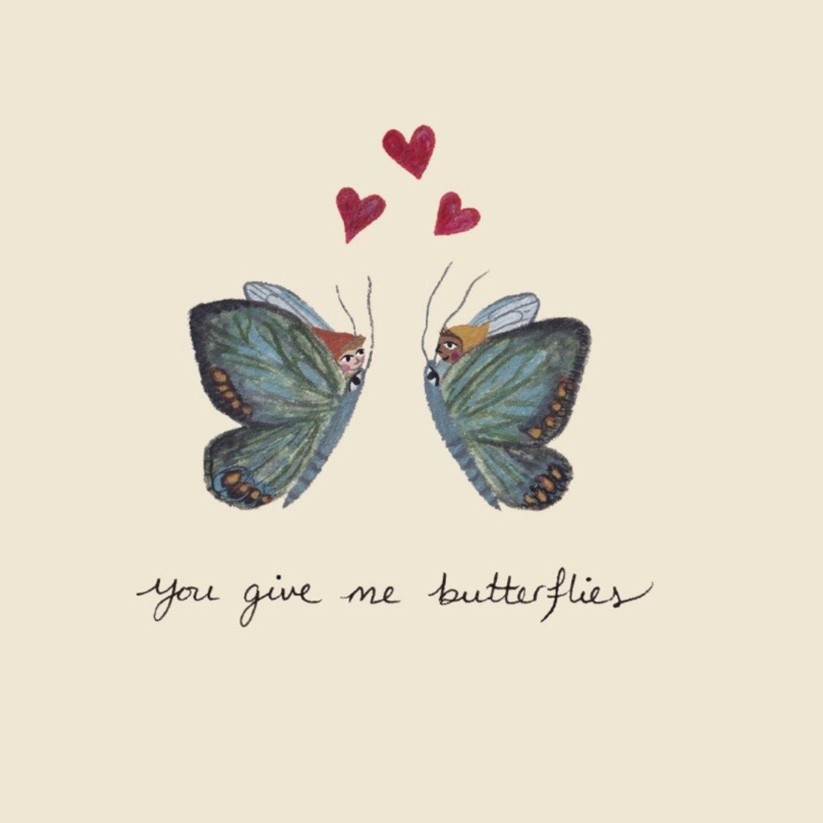 Close up of card featuring a whimsical illustration of two blue-green butterflies facing each other, with three small red hearts above them and the handwritten phrase 'you give me butterflies' below, all on a warm cream background.