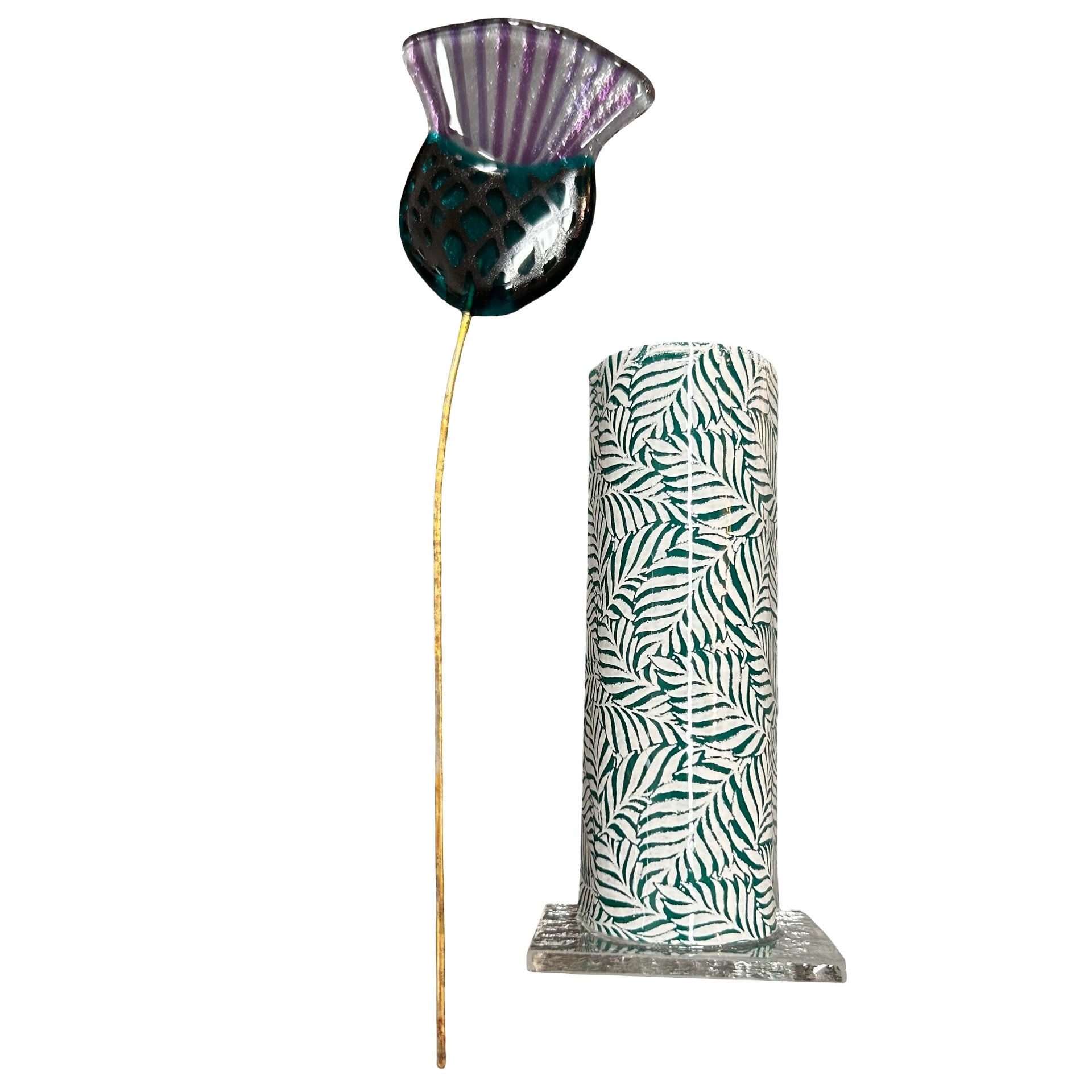 Decorative vase with leaf pattern and a thistle on a white background.