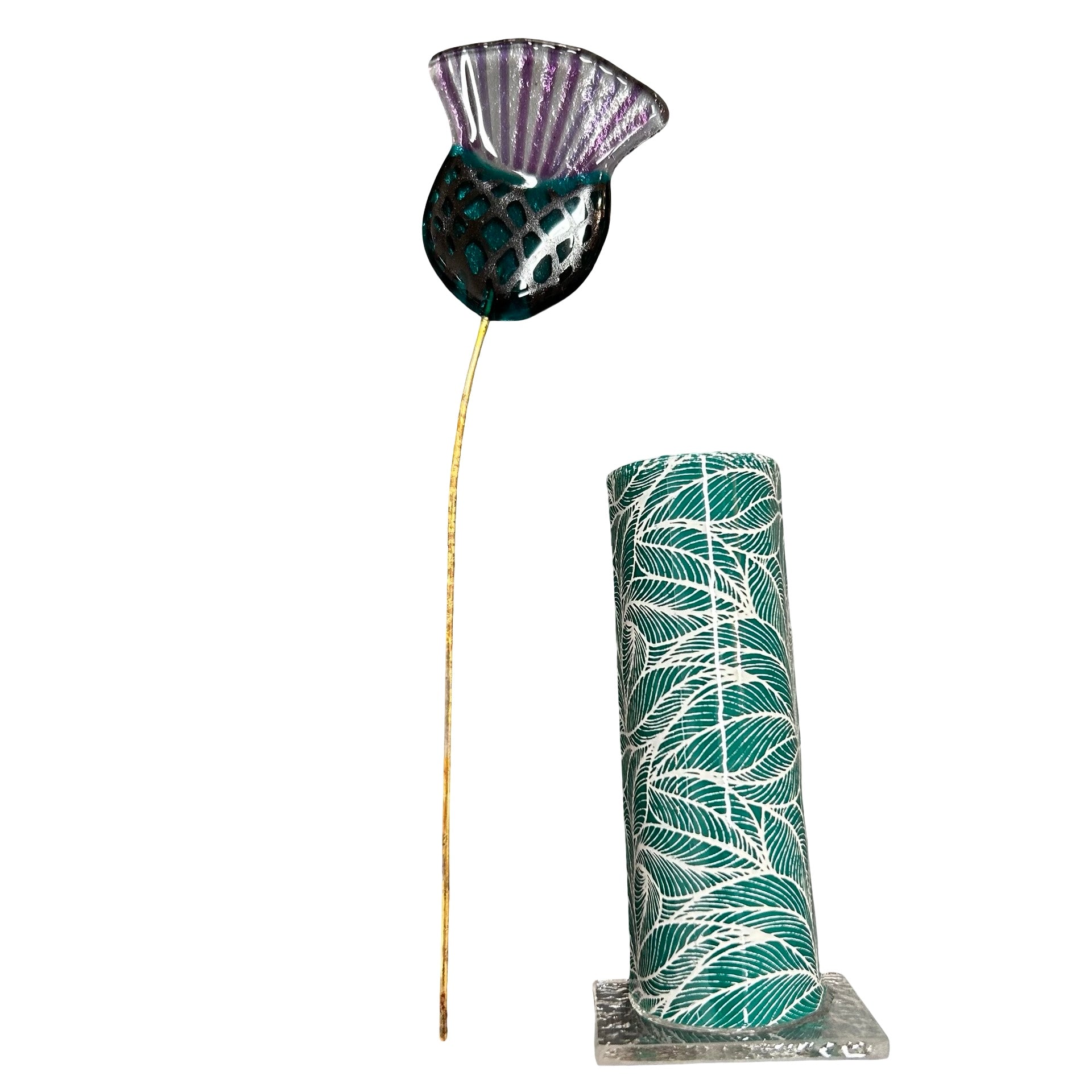 Decorative vase with leaf pattern and a glass thistle on a white background.