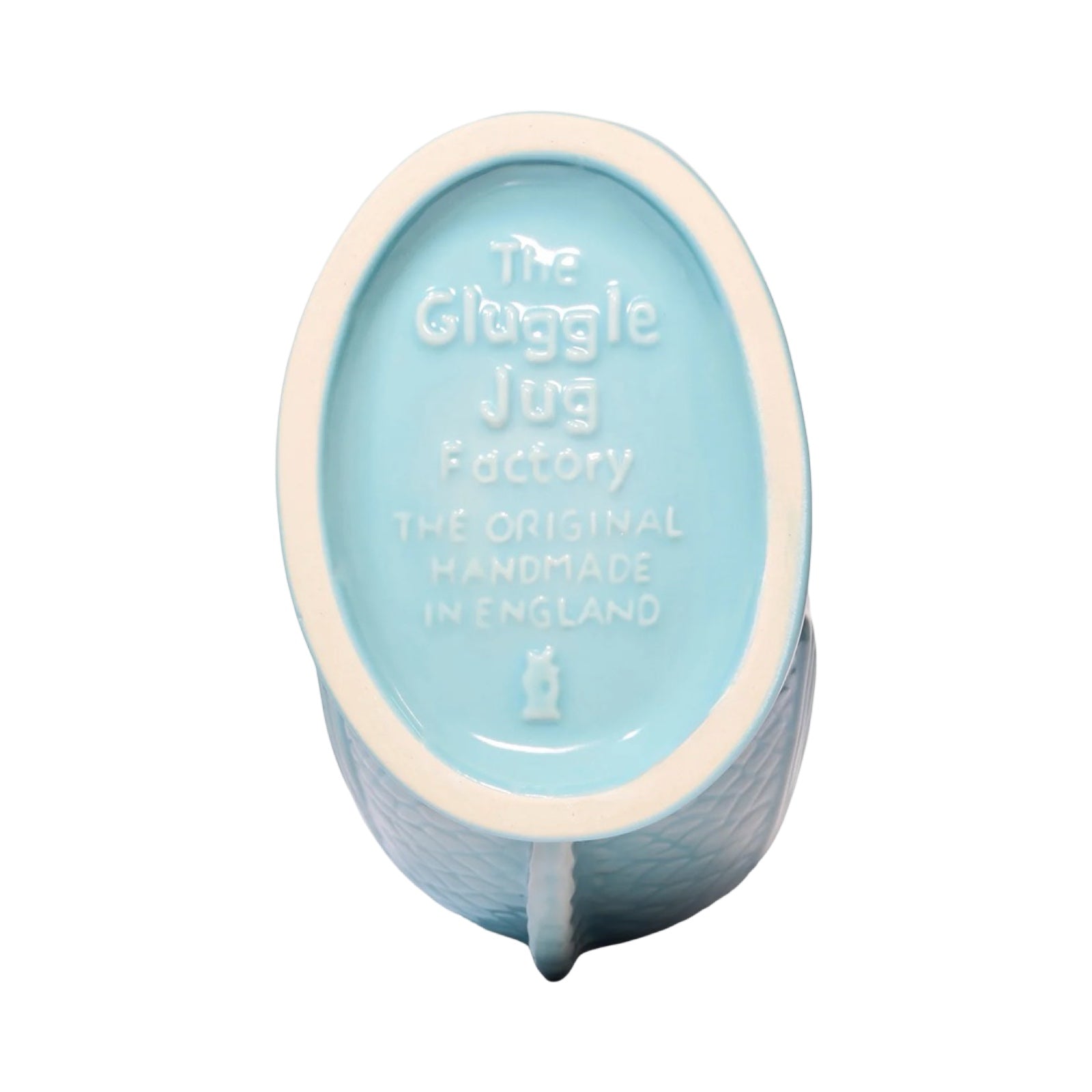 A mint coloured fish shaped gluggle jug.