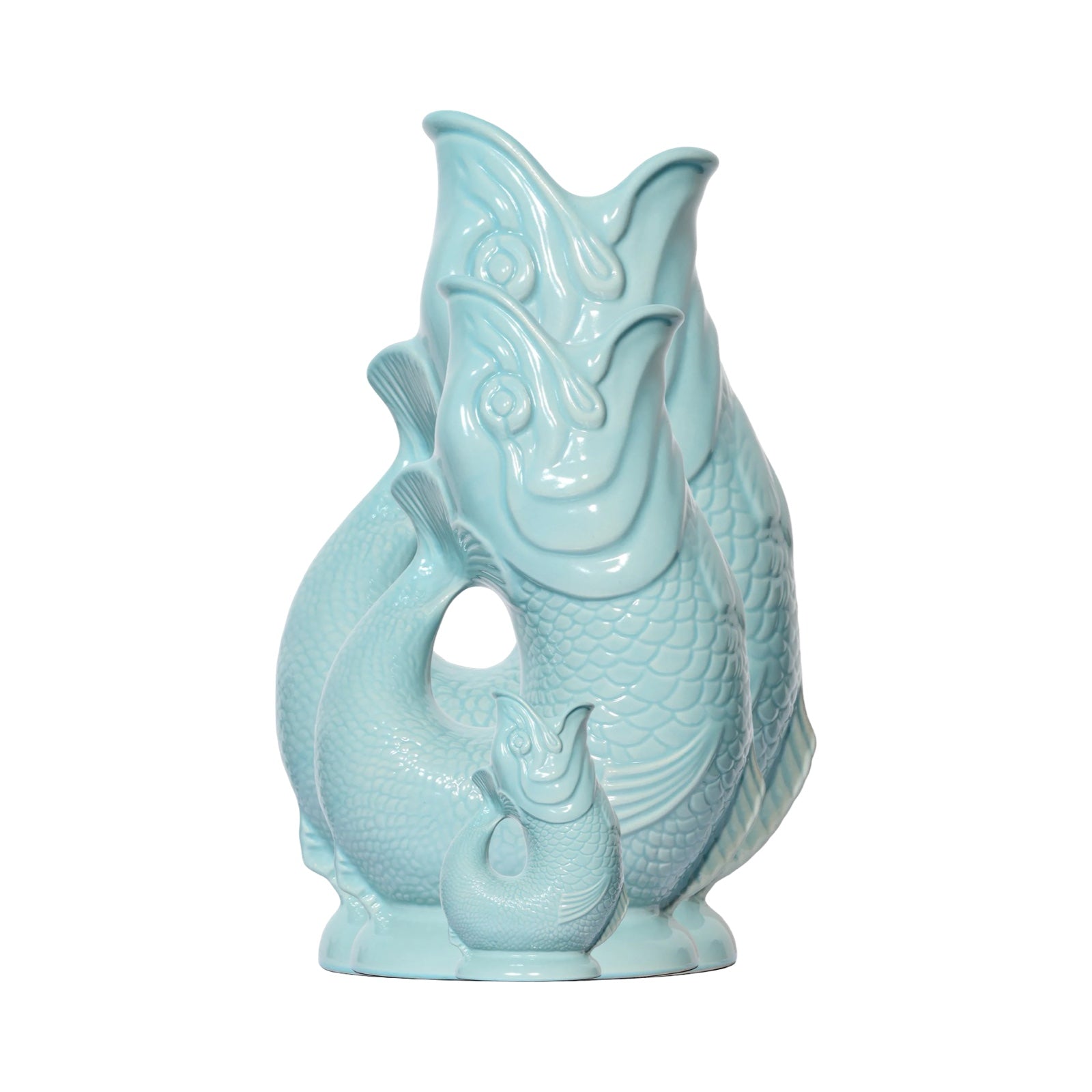 A mint coloured fish shaped gluggle jug.