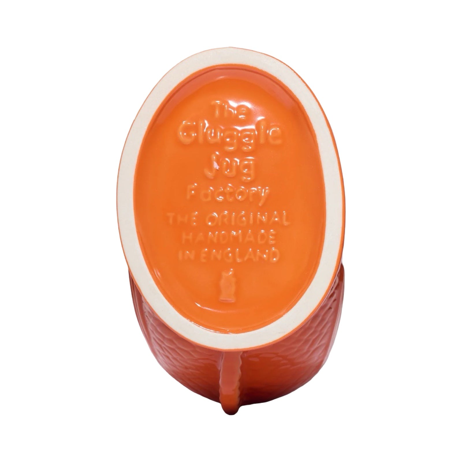 An orange fish shaped gluggle jug.