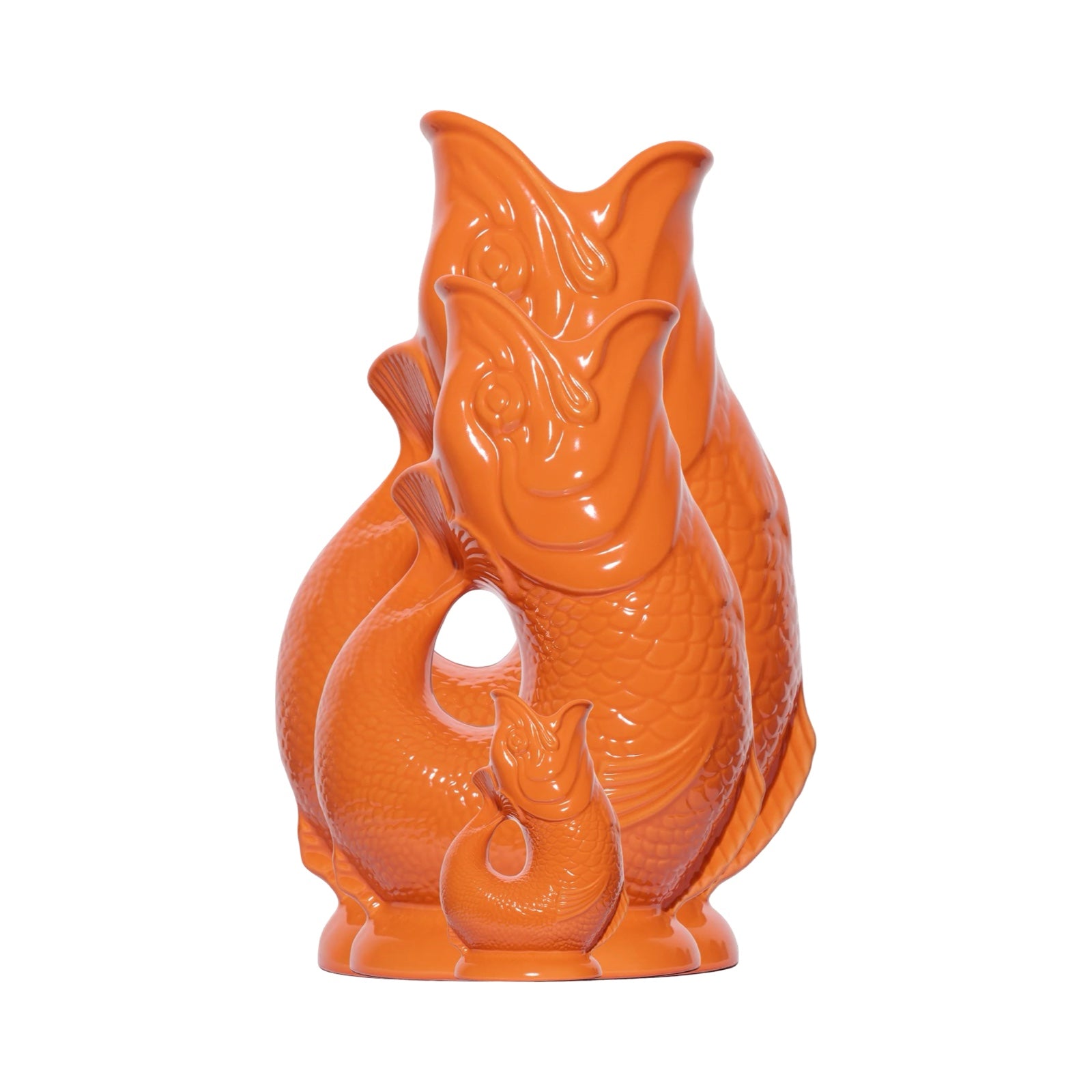 An orange fish shaped gluggle jug.