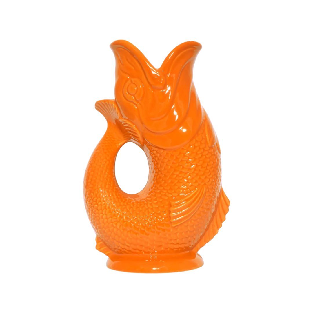 An orange fish shaped gluggle jug.