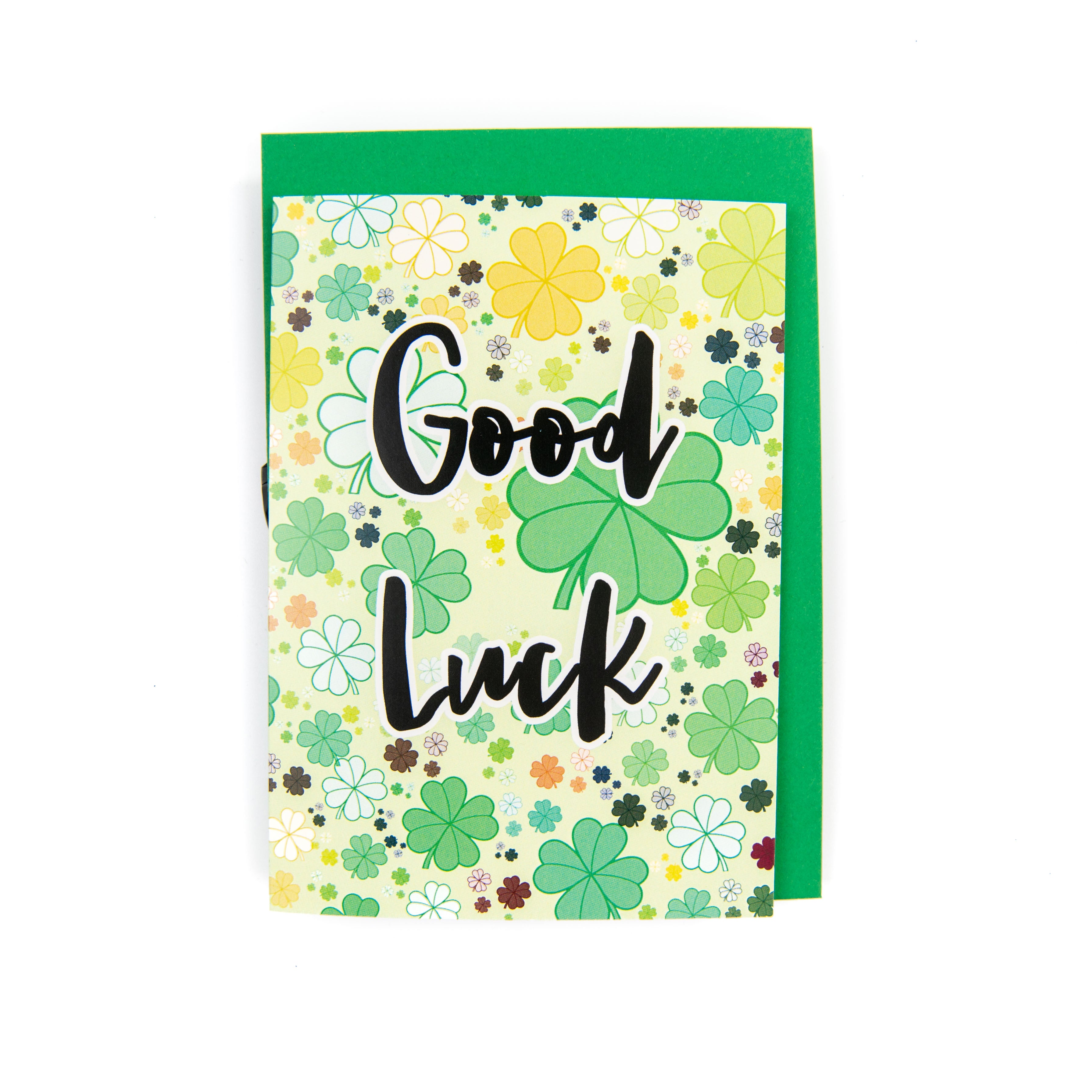 A greeting card with 'Good Luck' text and a background pattern of clover leaves, with an envelope included.