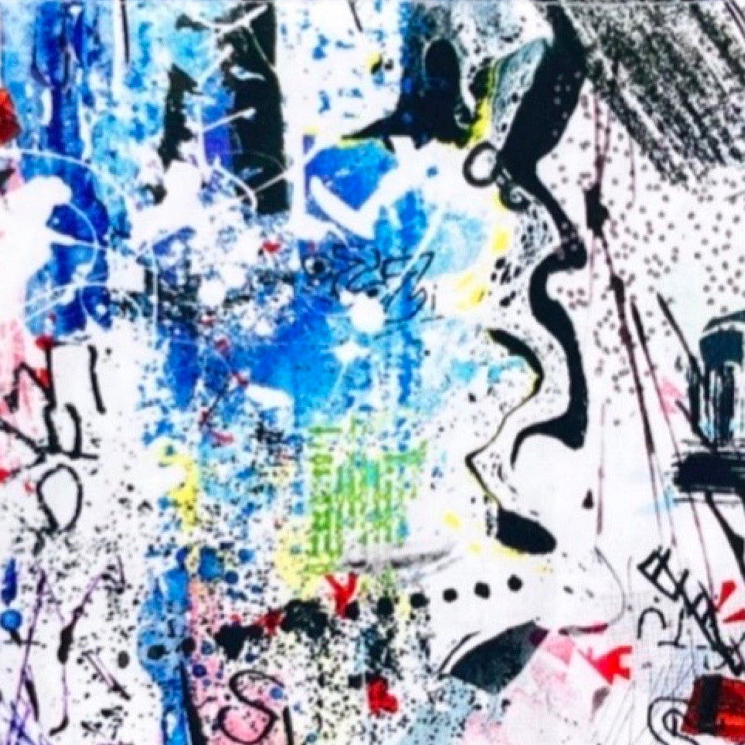 A white bandana bib with a graffiti print design.