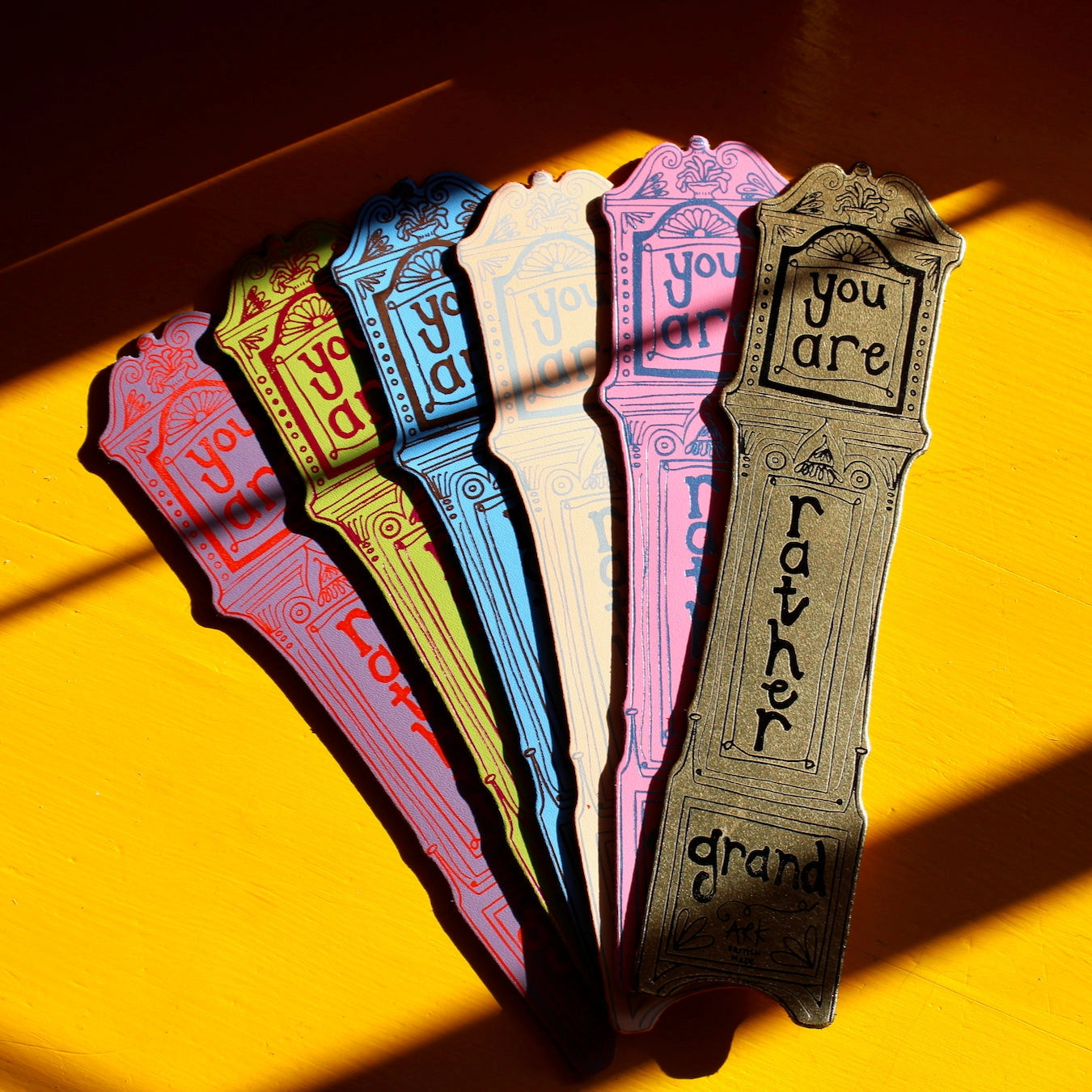 Set of colourful bookmarks with text on a yellow background.