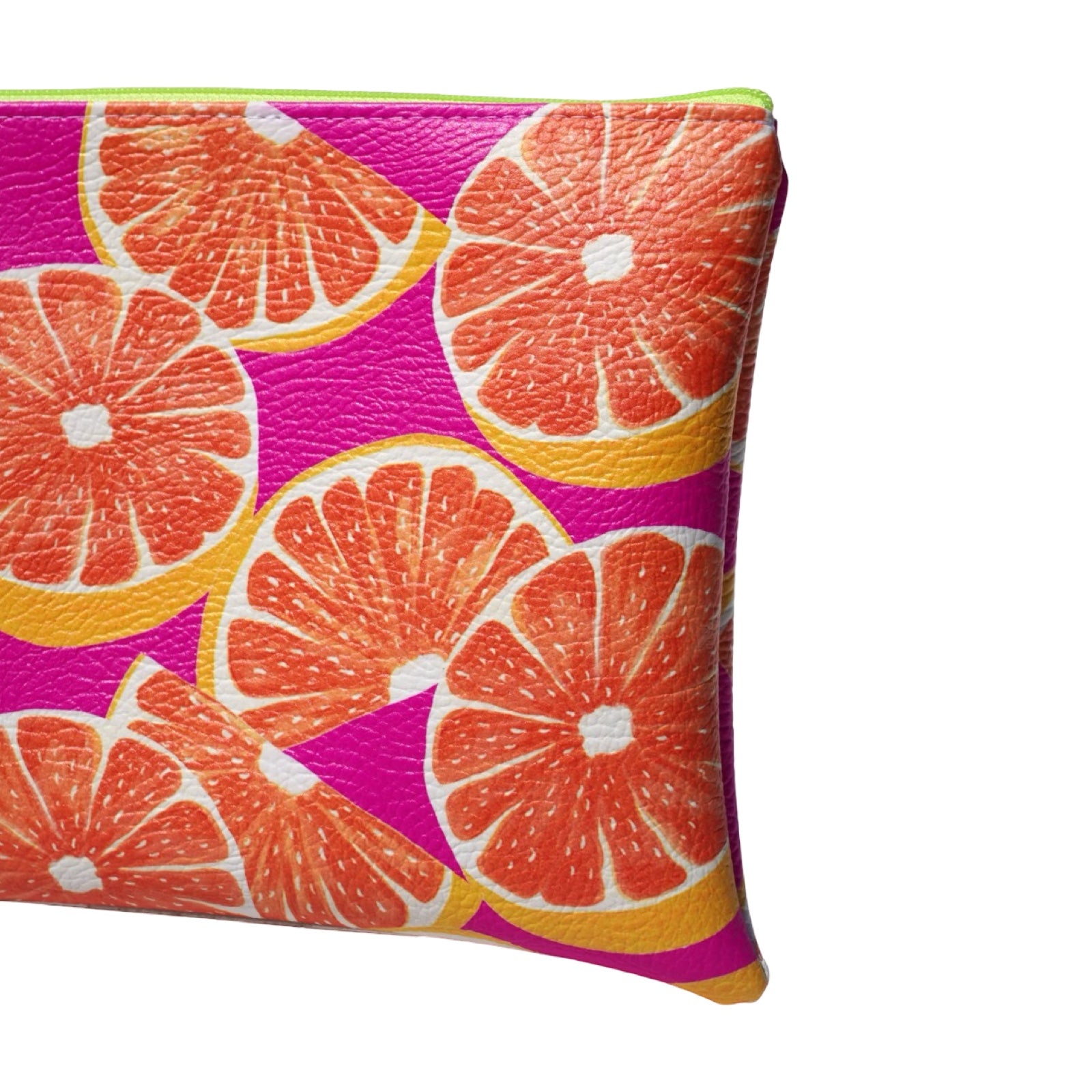 Vegan leather bag with a colourful grapefruit against a bright pink background, and the bag is finished with a fabulous matching tassel on the end of the zip.