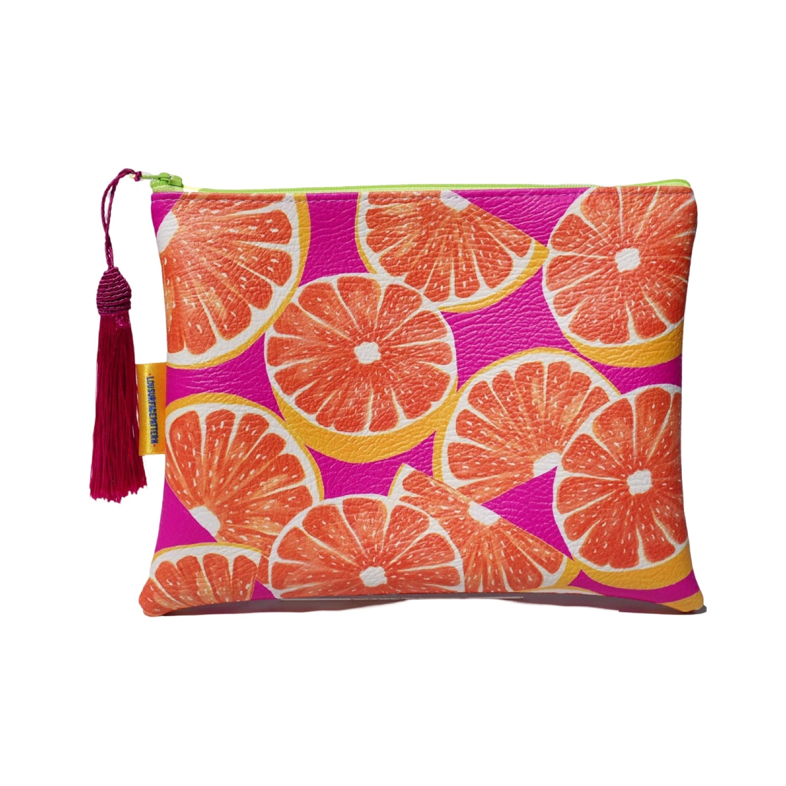 Vegan leather bag with a colourful grapefruit against a bright pink background, and the bag is finished with a fabulous matching tassel on the end of the zip.