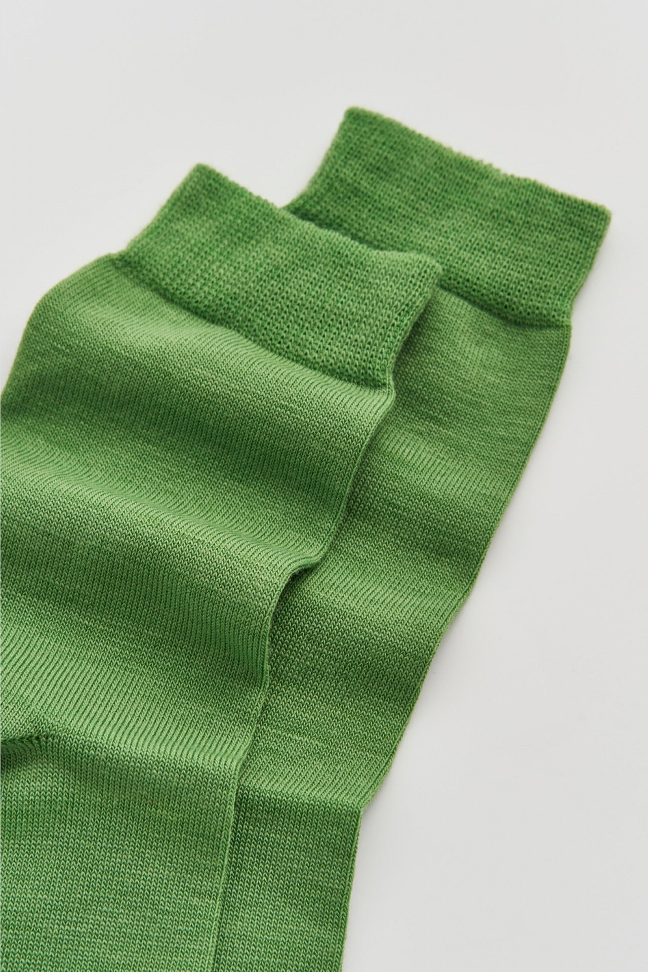 Close-up of green socks on a light background.