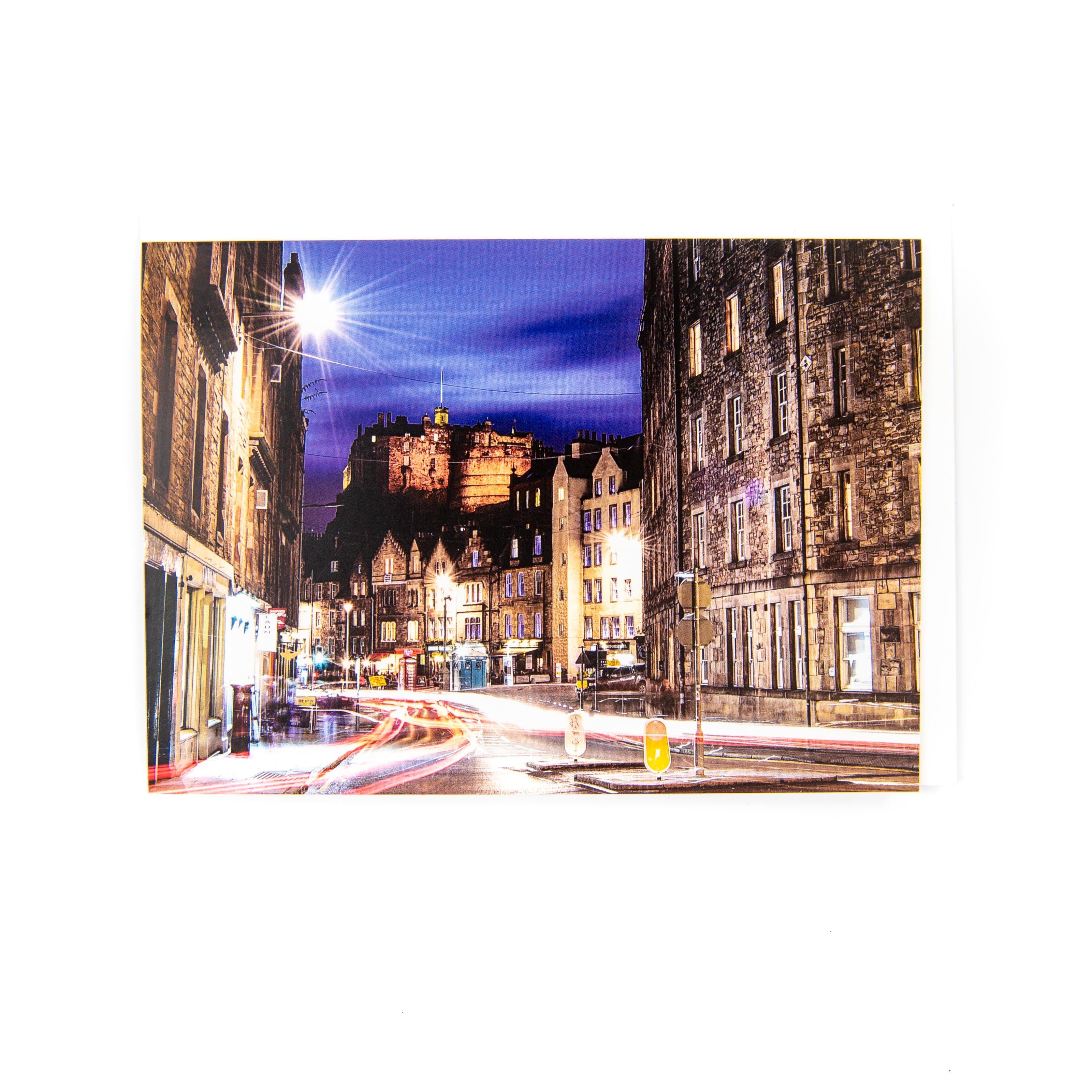 A greeting card featuring a photograph of Edinburgh Castle from Grassmarket, with a street scene in the foreground.