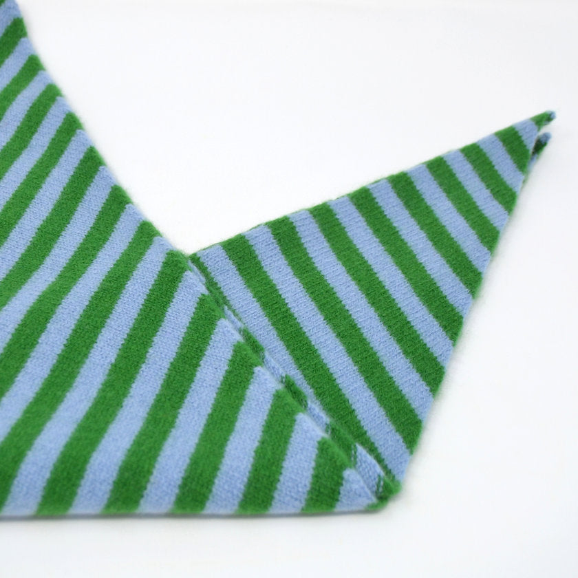 Green and blue striped fabric on a white background.