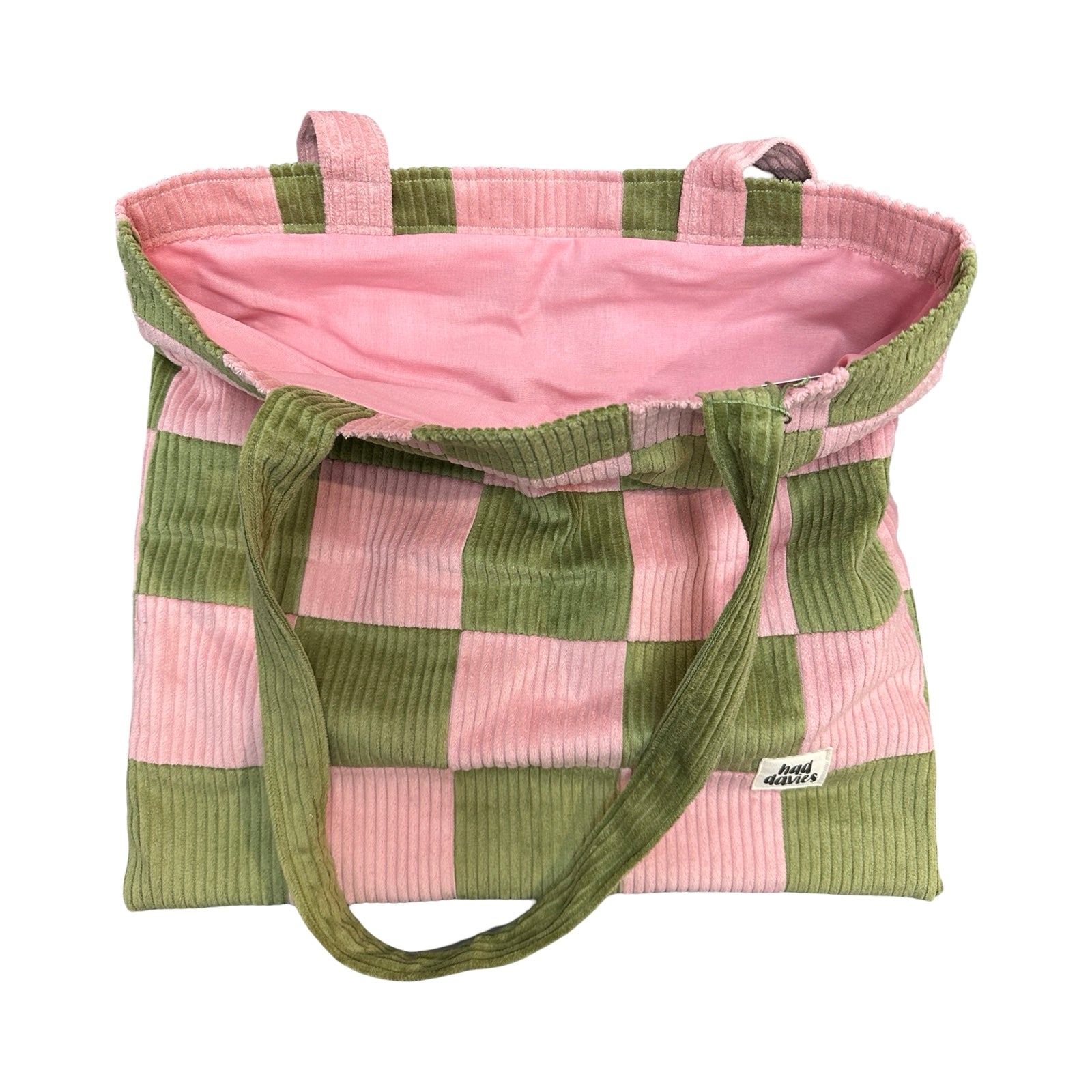 Pink and green checkered bag with ribbed texture on a white background.