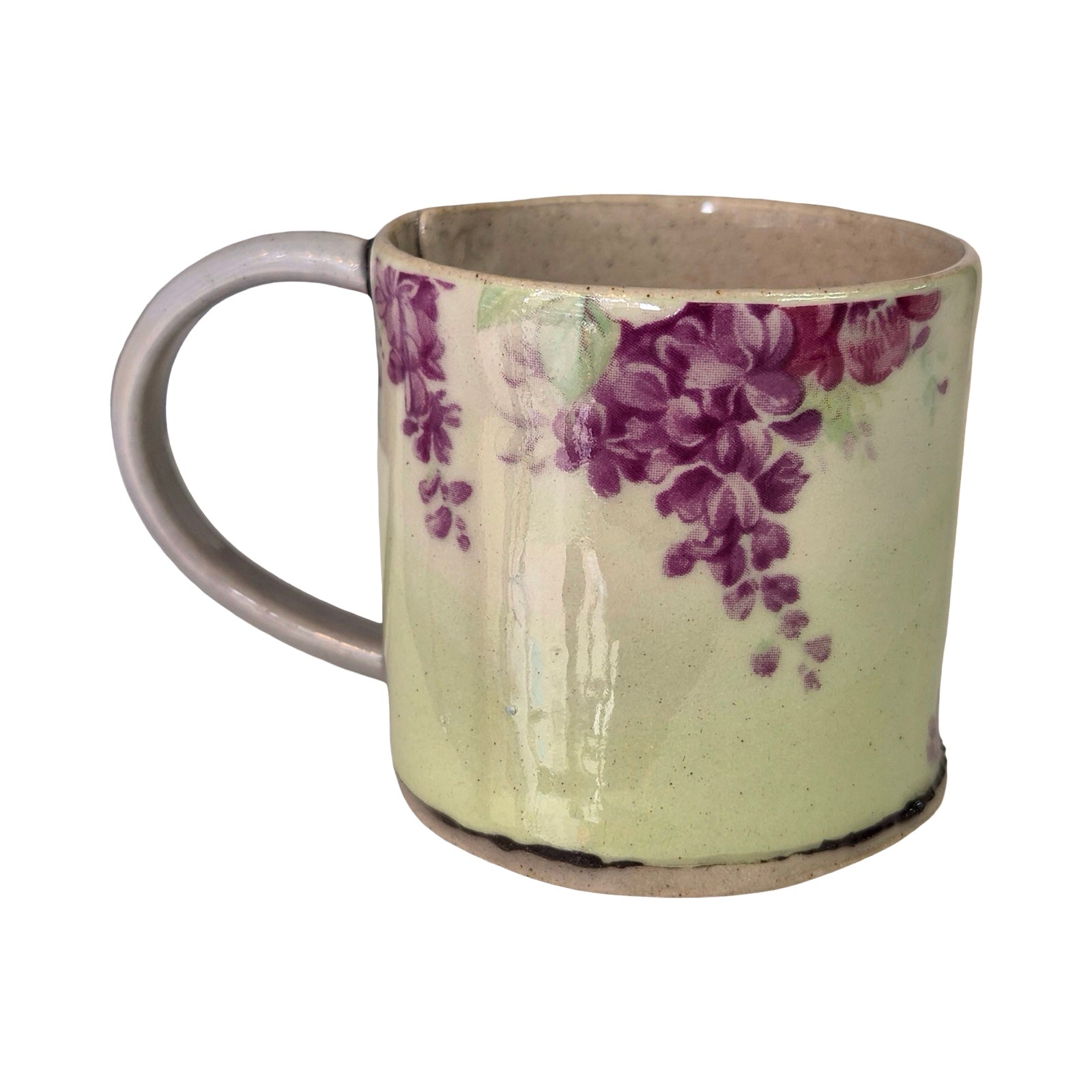 Ceramic mug with purple floral design on a white background.