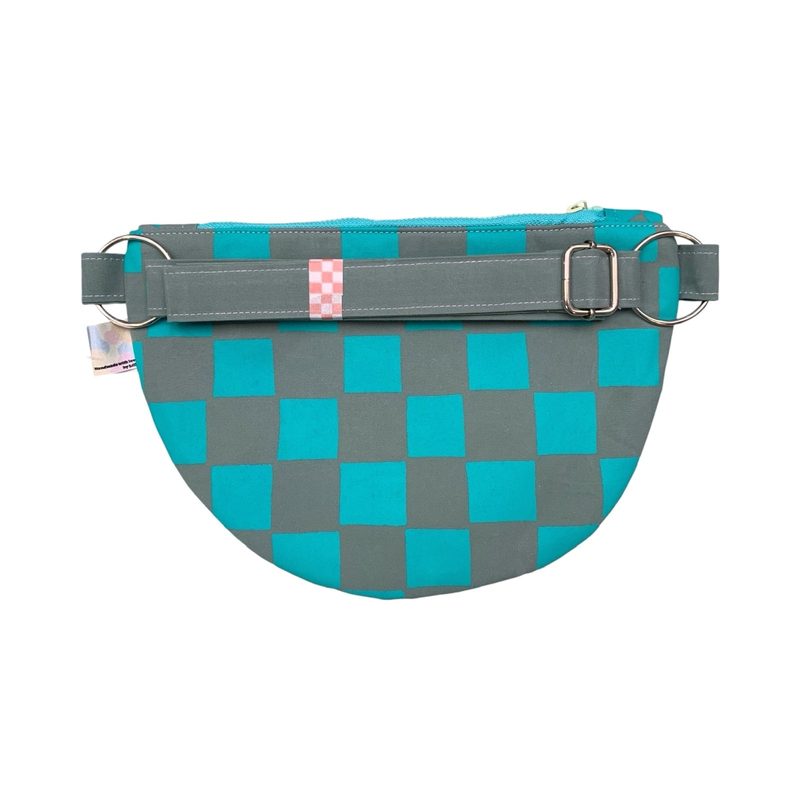 The back of a green checked cross body bag.