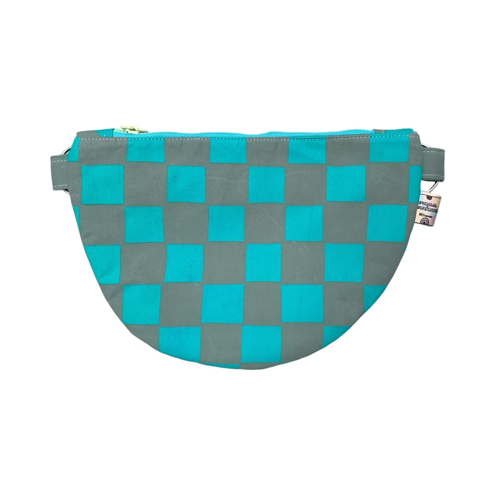 A green and grey checked cross body bag.