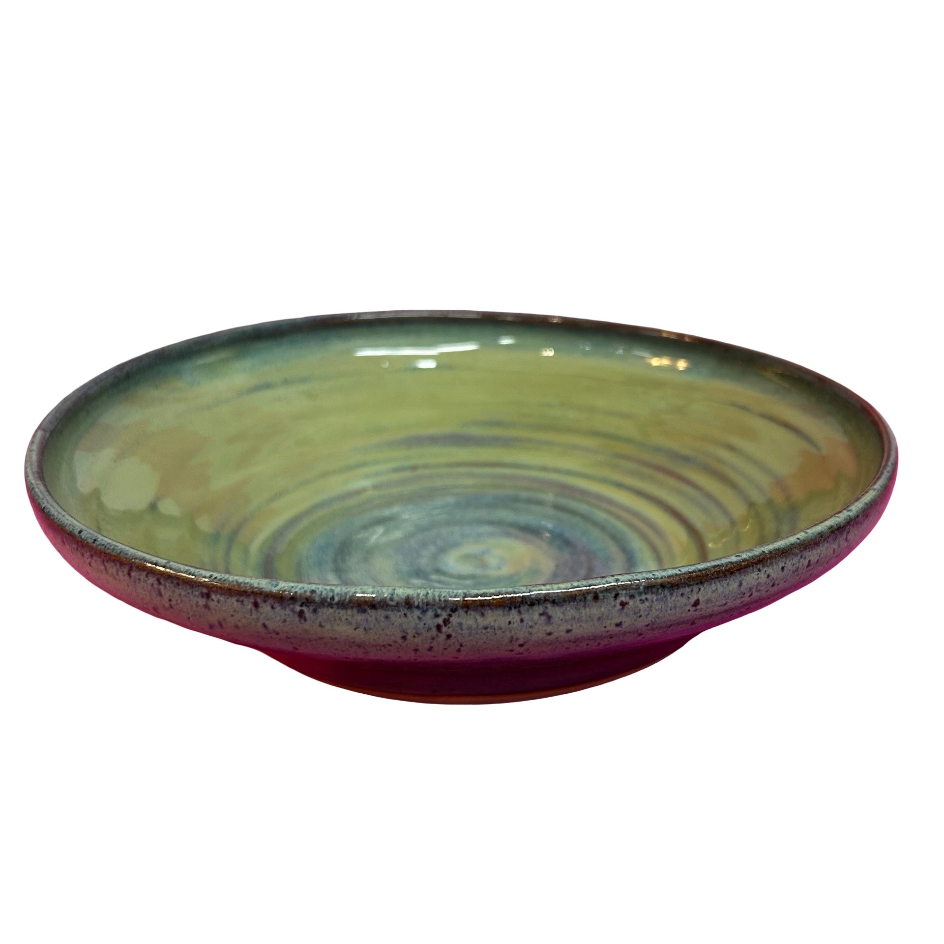 Ceramic bowl with multicoloured glaze on a white background.