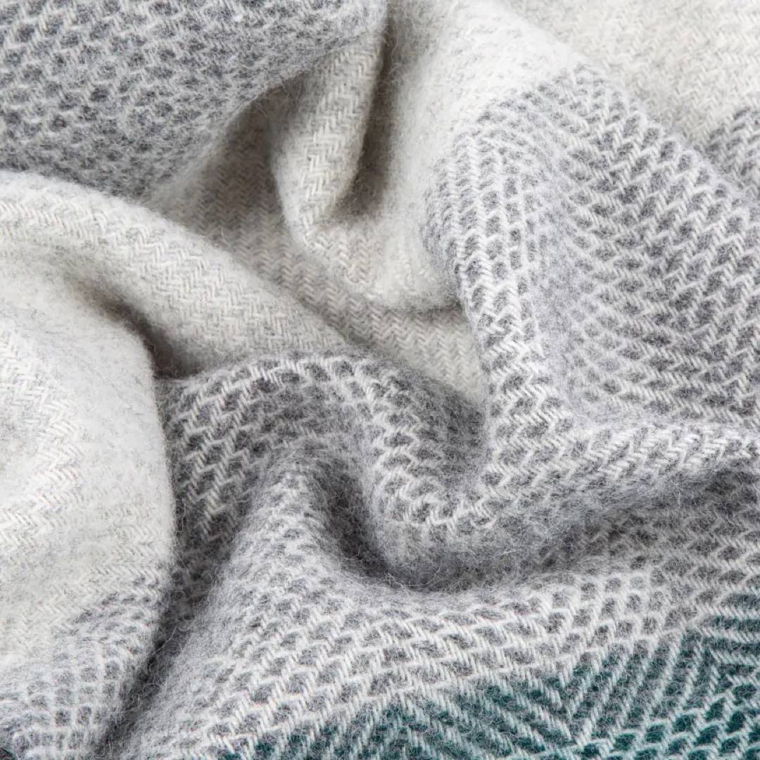 This grey and green striped super cosy and fluffy blanket is made from 100% pure new wool and finished with extra brushing to make it super soft.