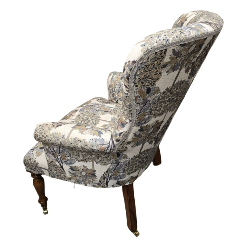 A hand-crafted occasional armchair covered in digitally printed cream cotton/linen blend fabric with a grey and beige tree design.