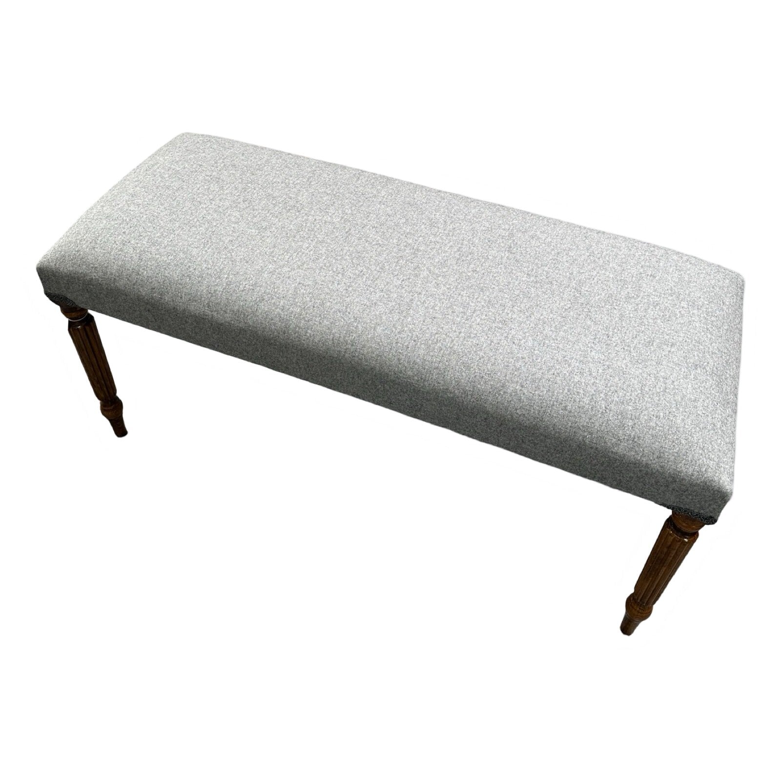 A rectangular grey wool bench with mahogany legs, upholstered and hand-crafted.