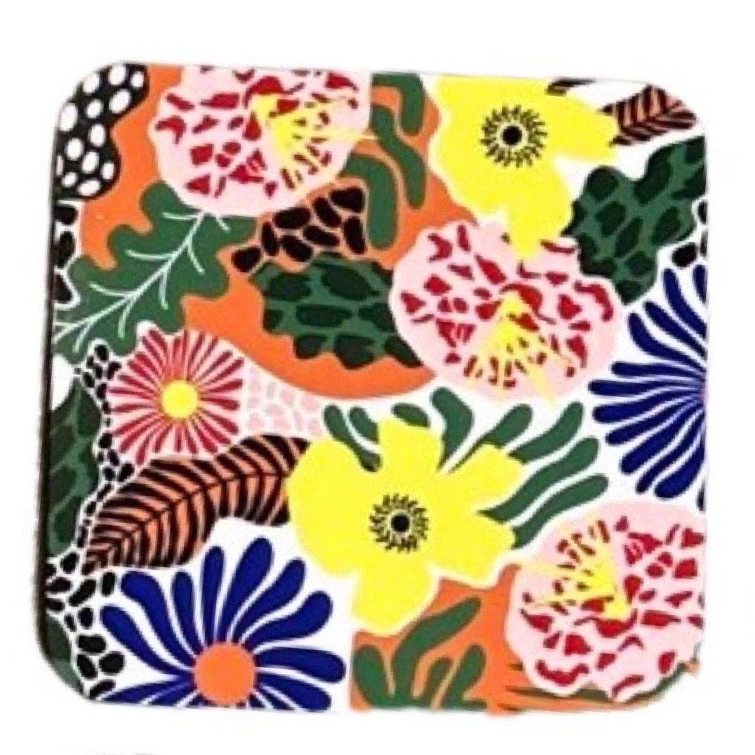 Floral coaster of colourful plants, flowers and leaves from the garden.