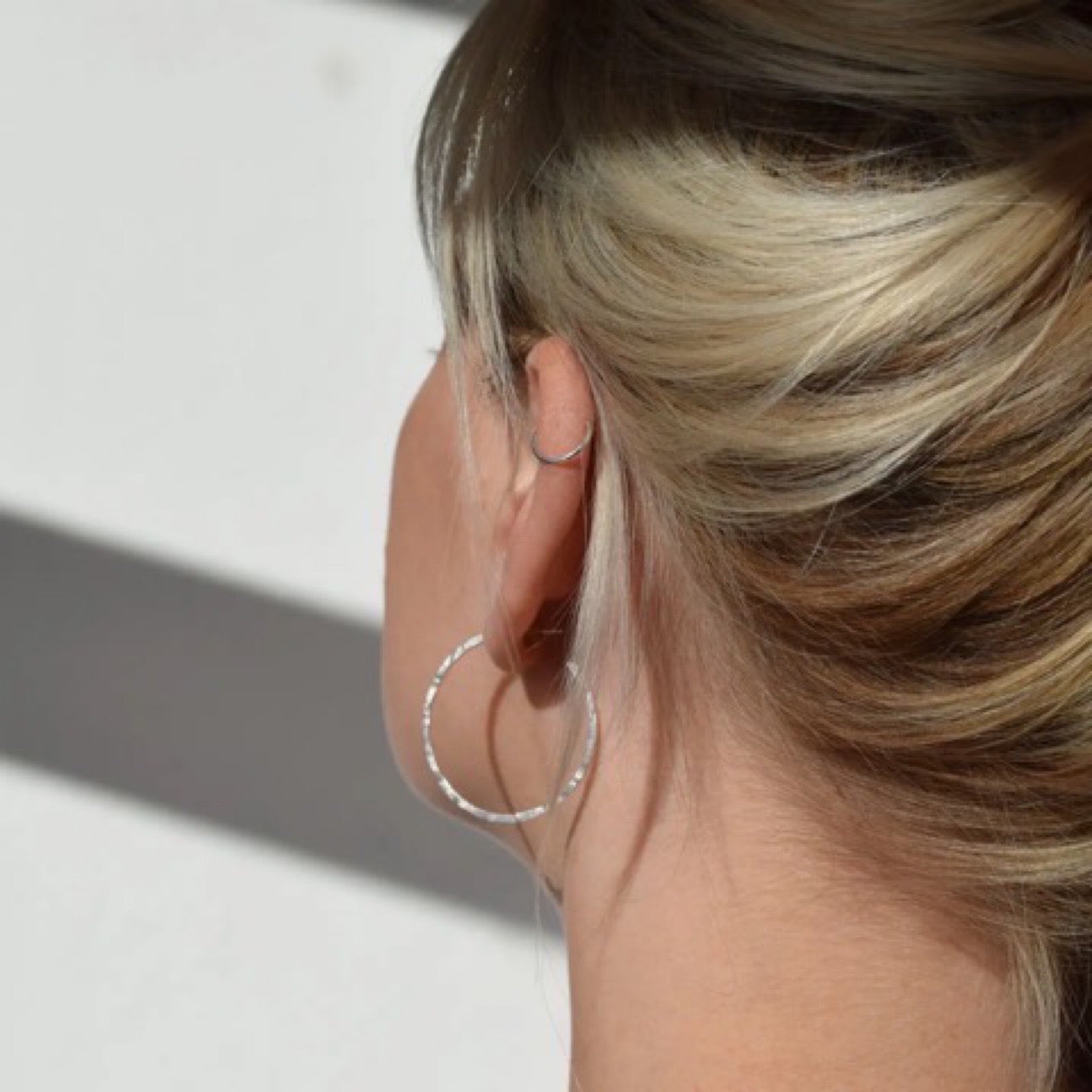 Silver hoop earrings made from recycled sterlings silver and given a slight beaten texture.