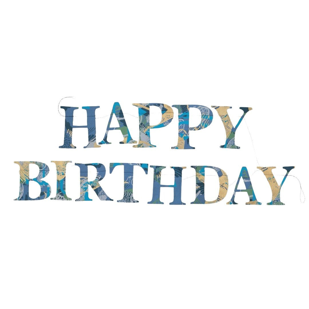 A happy birthday paper garland in blue, yellow and green patterned letters.