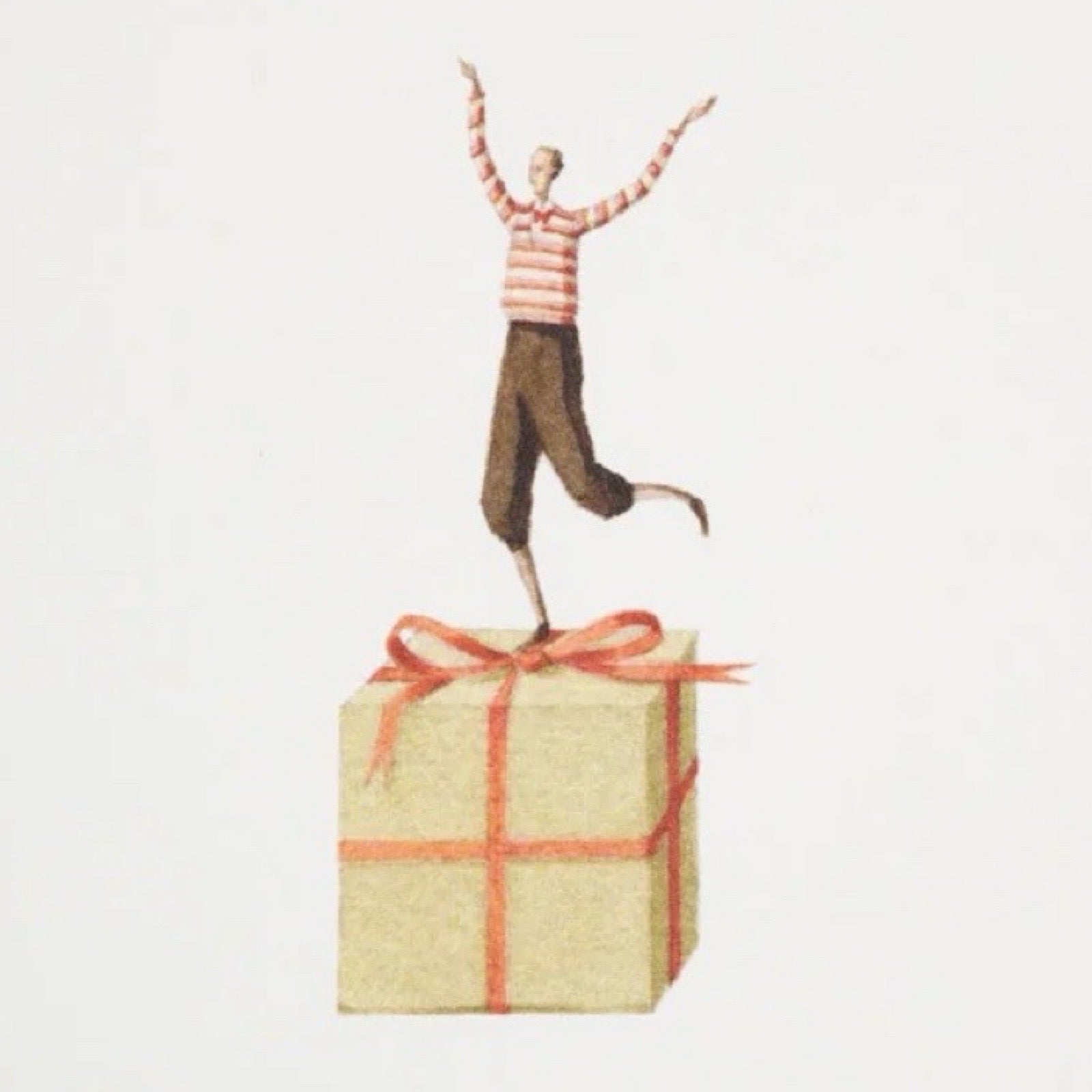 Small figurine of a person in a striped shirt and pants standing on top of a gift box with an orange ribbon against a light gray background.