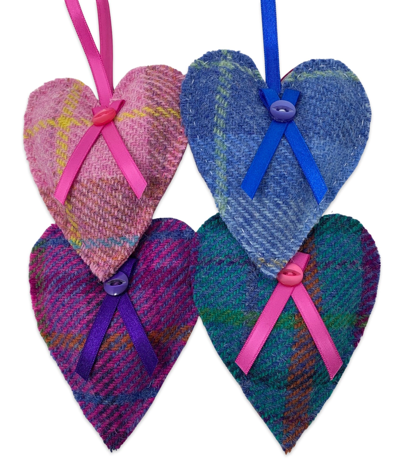 Four Harris tweed lavender hearts with ribbon bow and button detail and a hanging loop. The hearts are pink, blue, purple and turquoise.