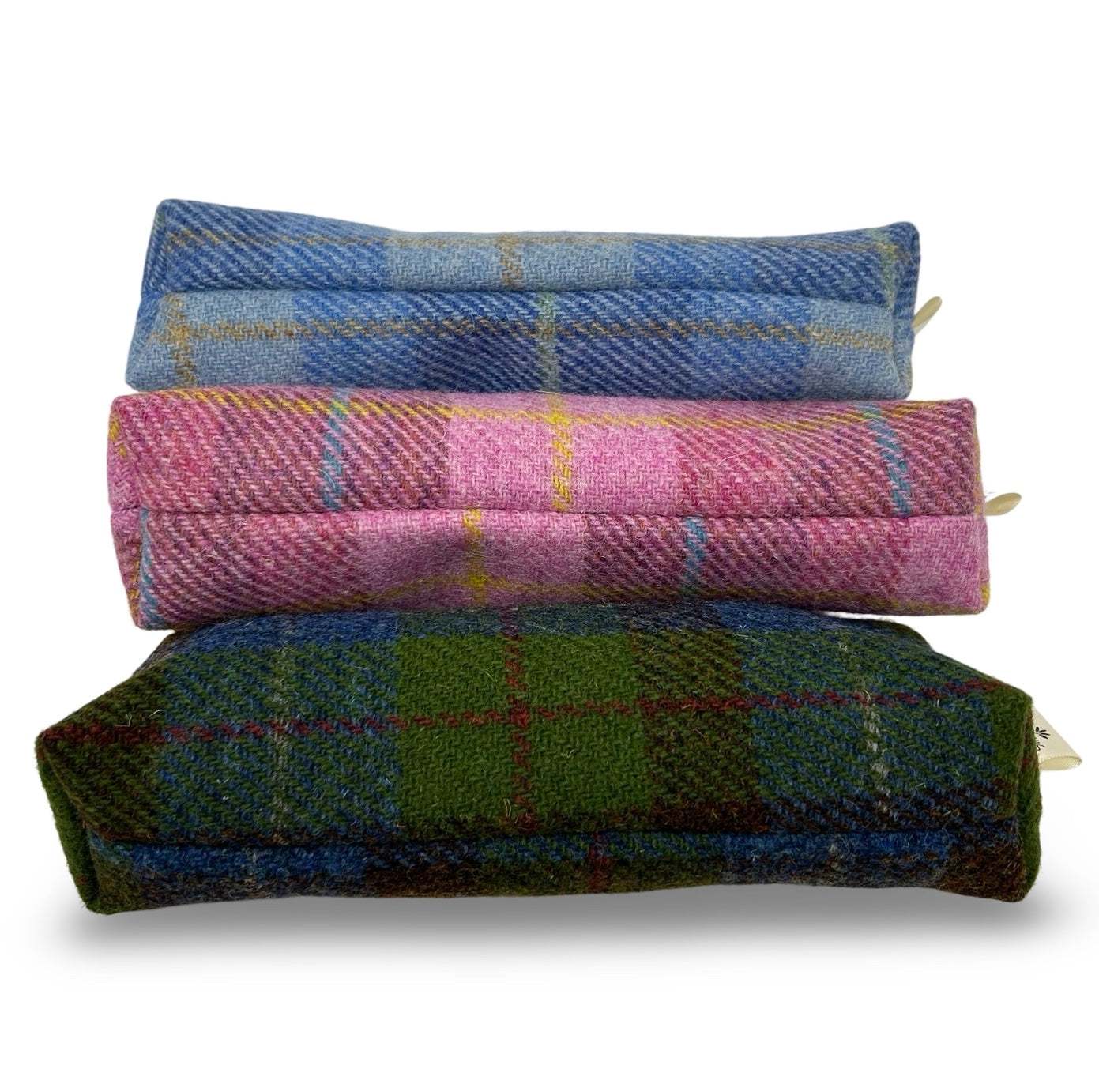 Showing the boxed base of the three colours of harris tweed pencil case.