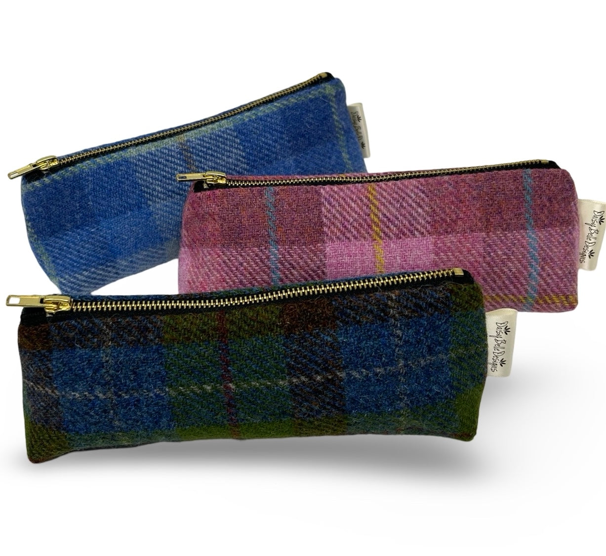 Three harris tweed pencil cases each with a gold zip