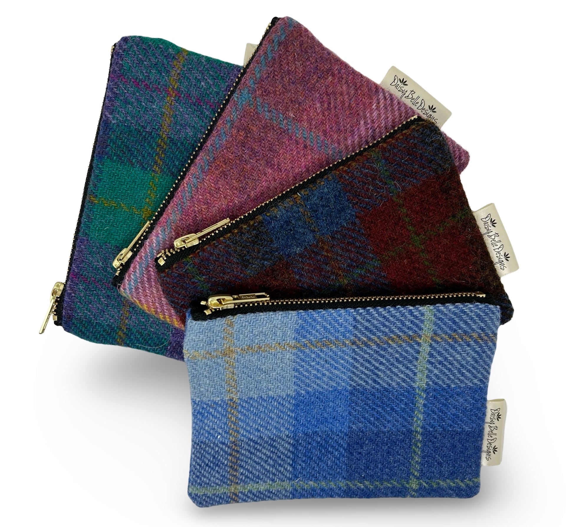 Four colours of large rectangular Harris tweed purse, each with a gold zip.
