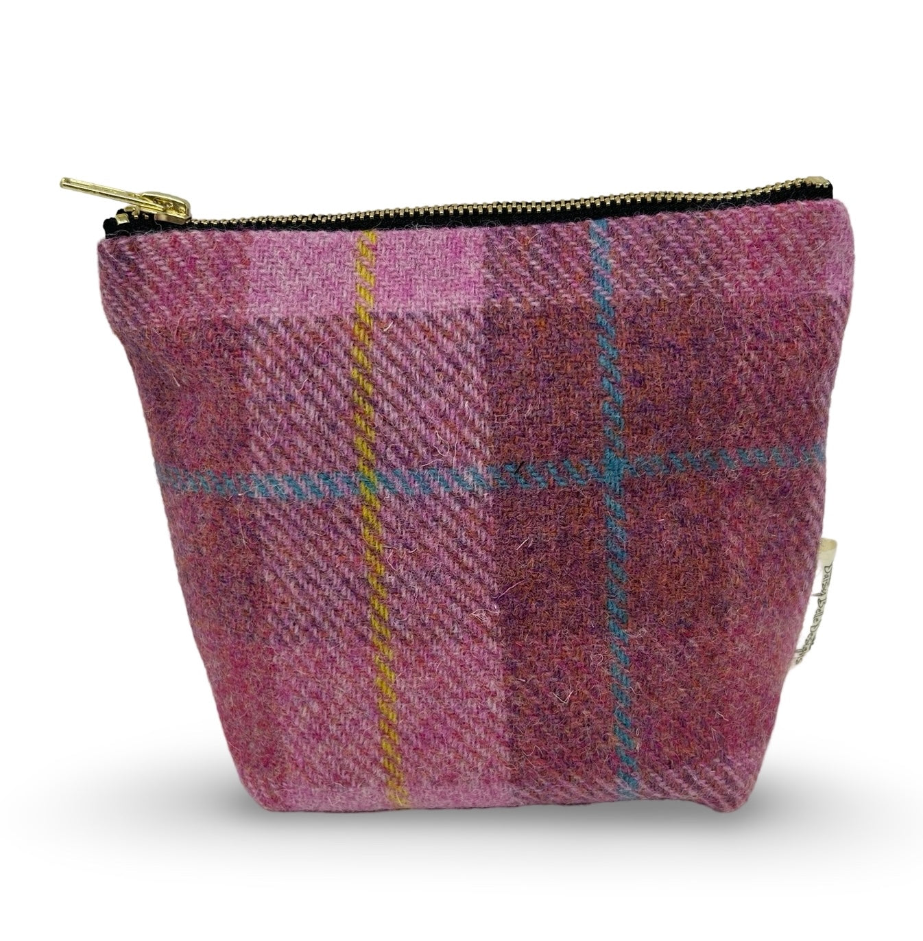 Small harris tweed toiletry bag in pink with a gold zip.