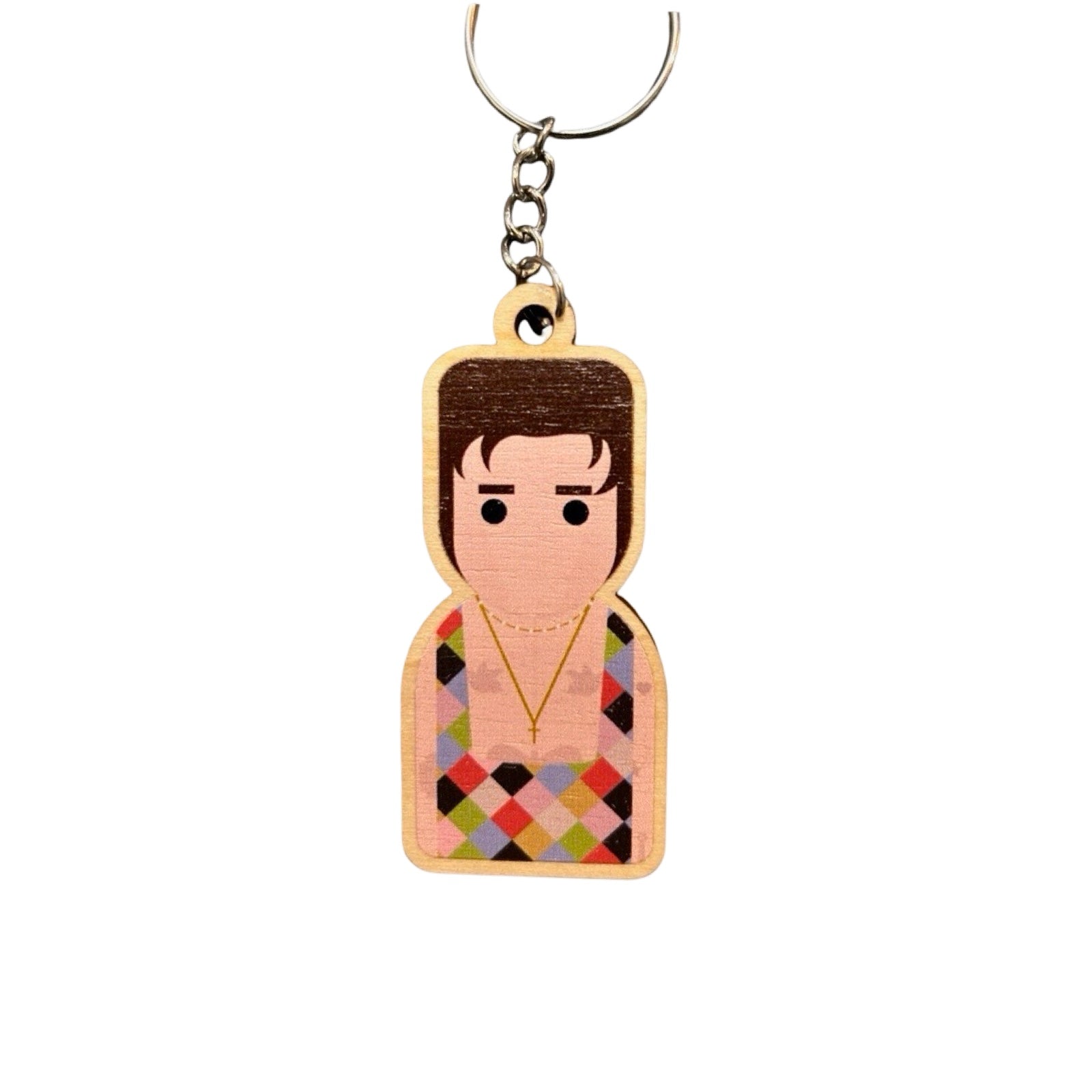 A wooden keyring decoration featuring a stylized representation of a person with a multicolored shirt.