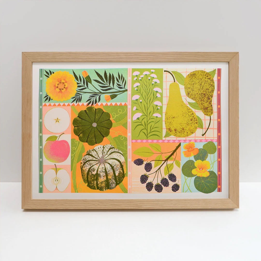Framed artwork with colorful illustrations of fruits and plants on a white background.