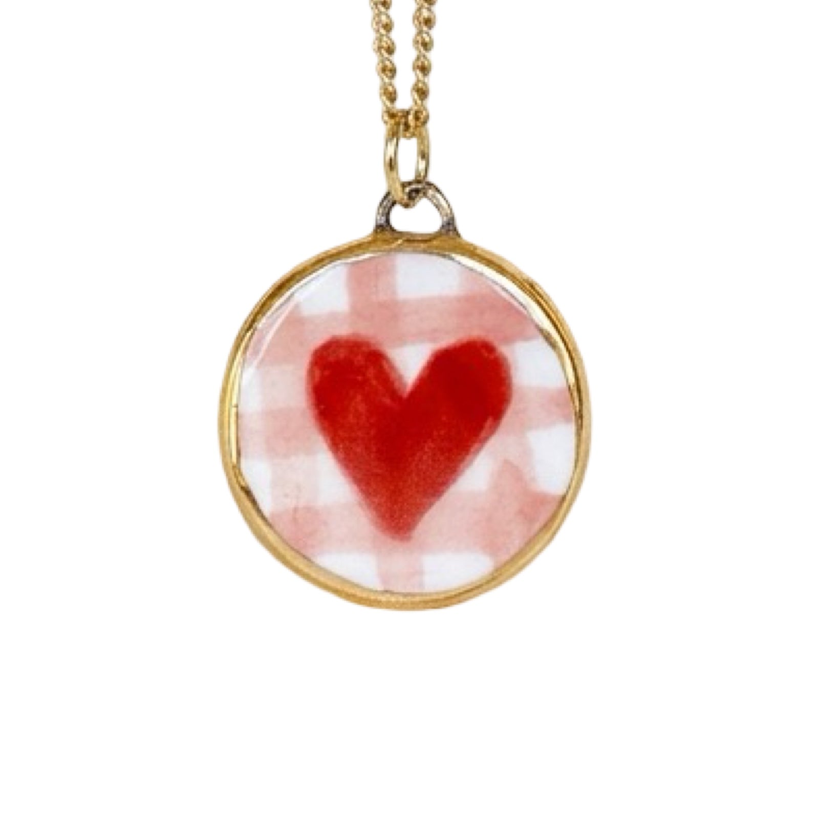 Necklace with a round pendant featuring a red heart design on a white background.