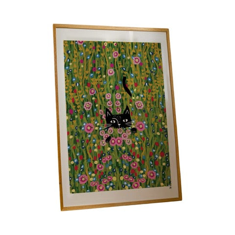Cat print featuring an illustration of a black cat peeking through the flowers in a meadow, based on the Gustav Klimt painting 'The Flower Garden'.