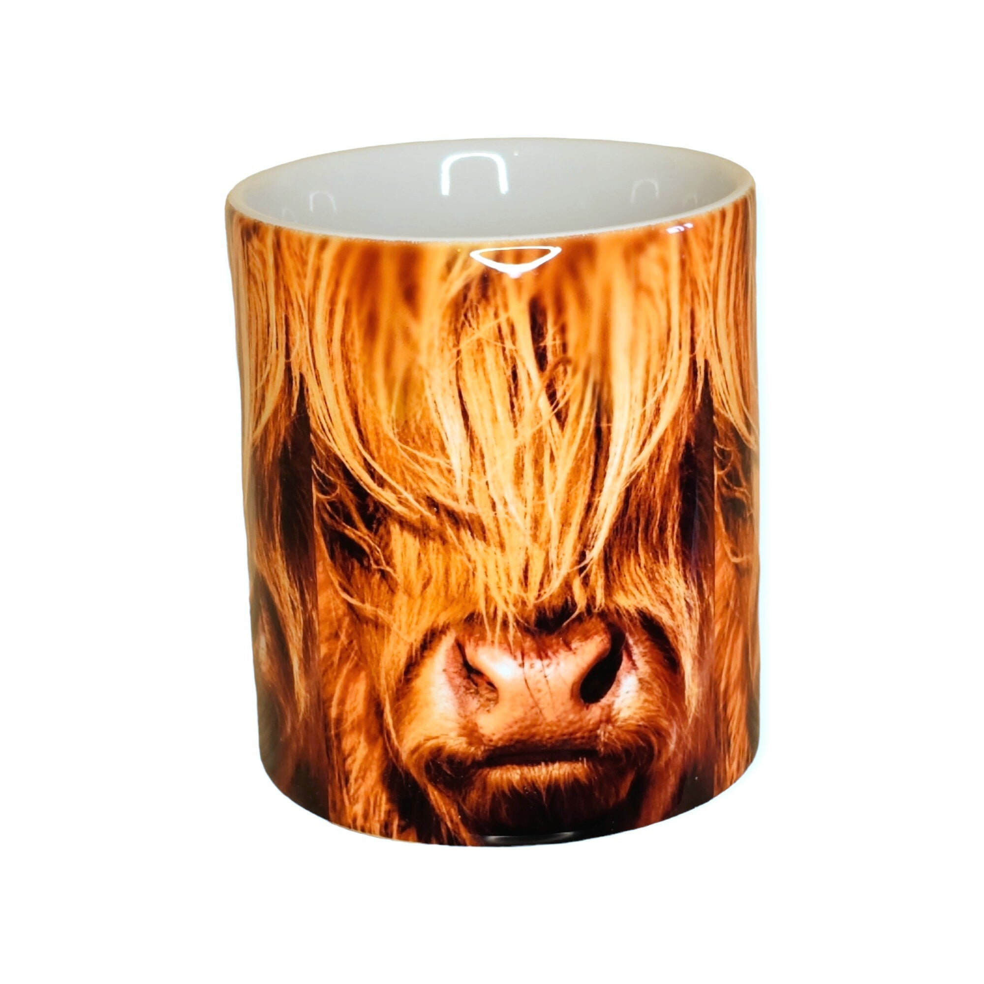 A mug featuring a Highland Cow on it.