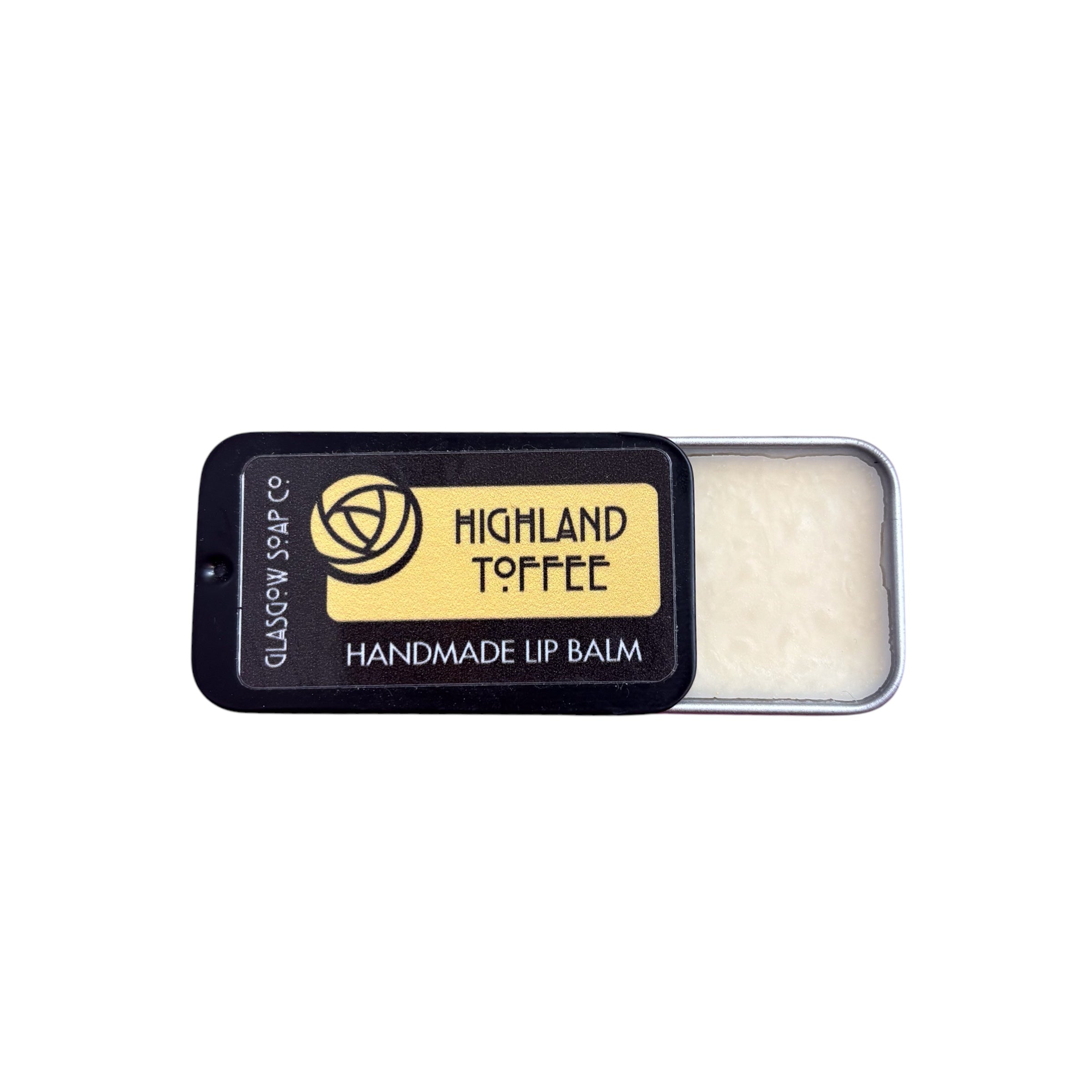 A small tin of highland toffee lip balm, half open.