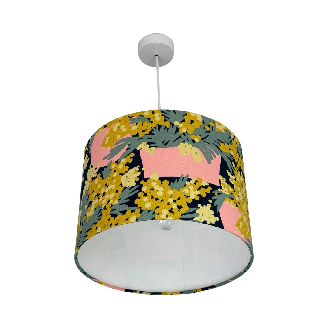 Navy drum lampshade with pink plant pots and green and yellow plants