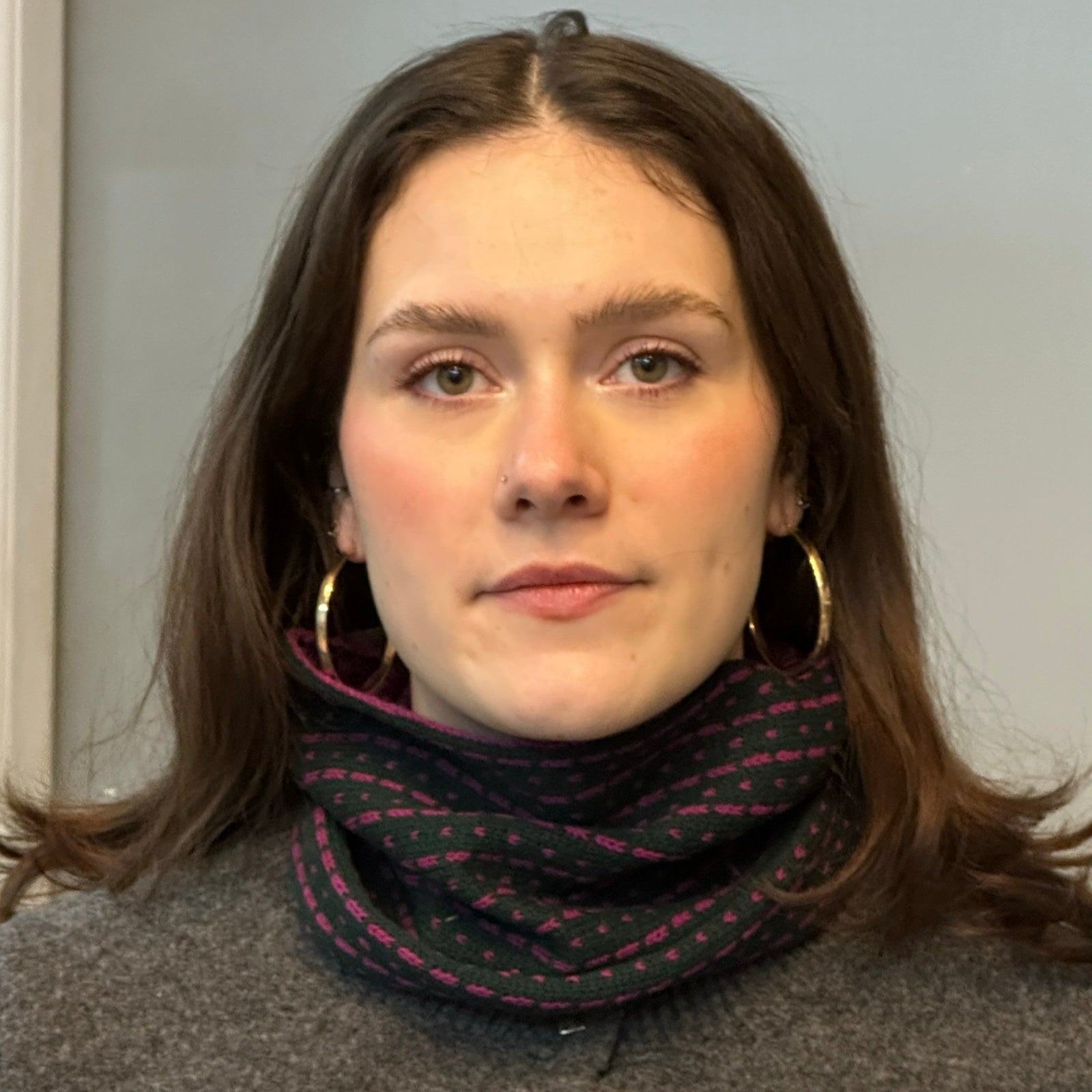 A cosy 100% lambswool knitted snood in navy with magenta dashes.