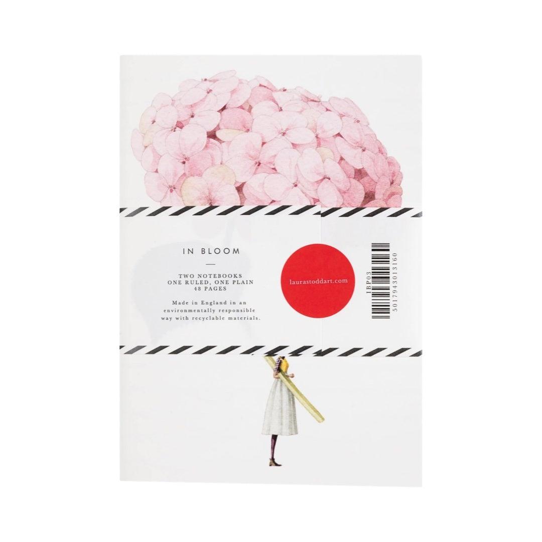 A notebook with a lady holding a giant hydrangea on the cover.