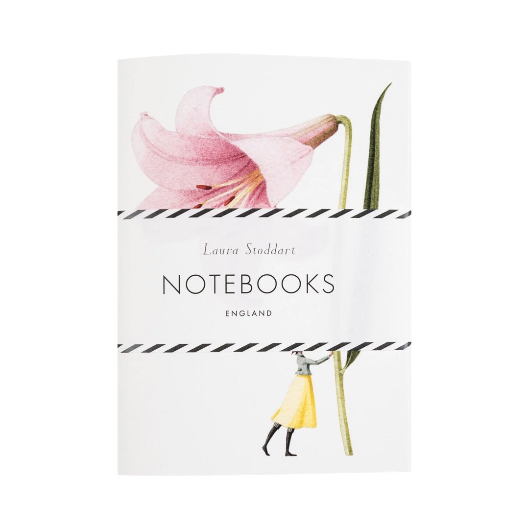 A notebook with a lady holding a giant lily on the cover.